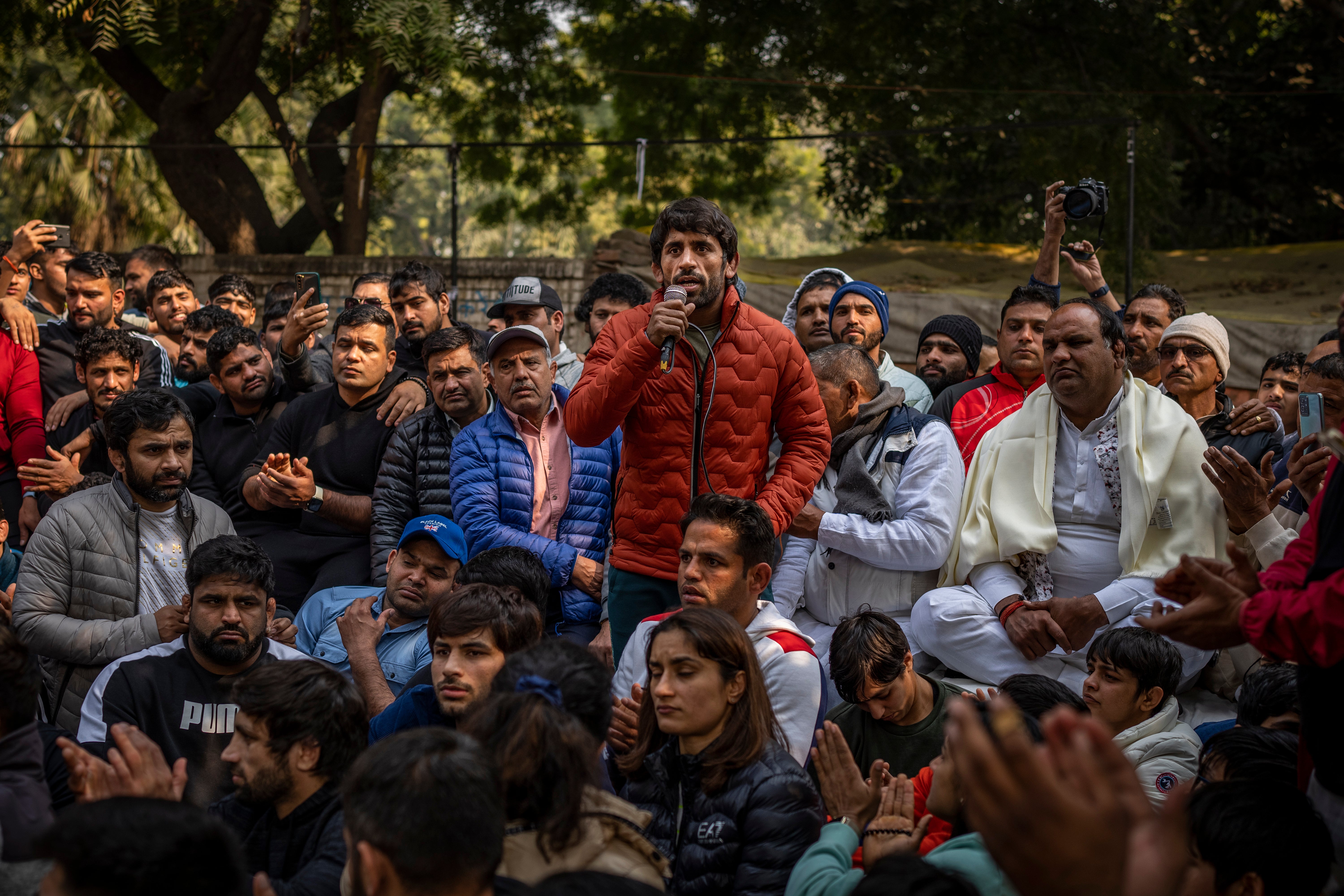 Indian wrestler Bajrang Punia, center, speaks during a protest