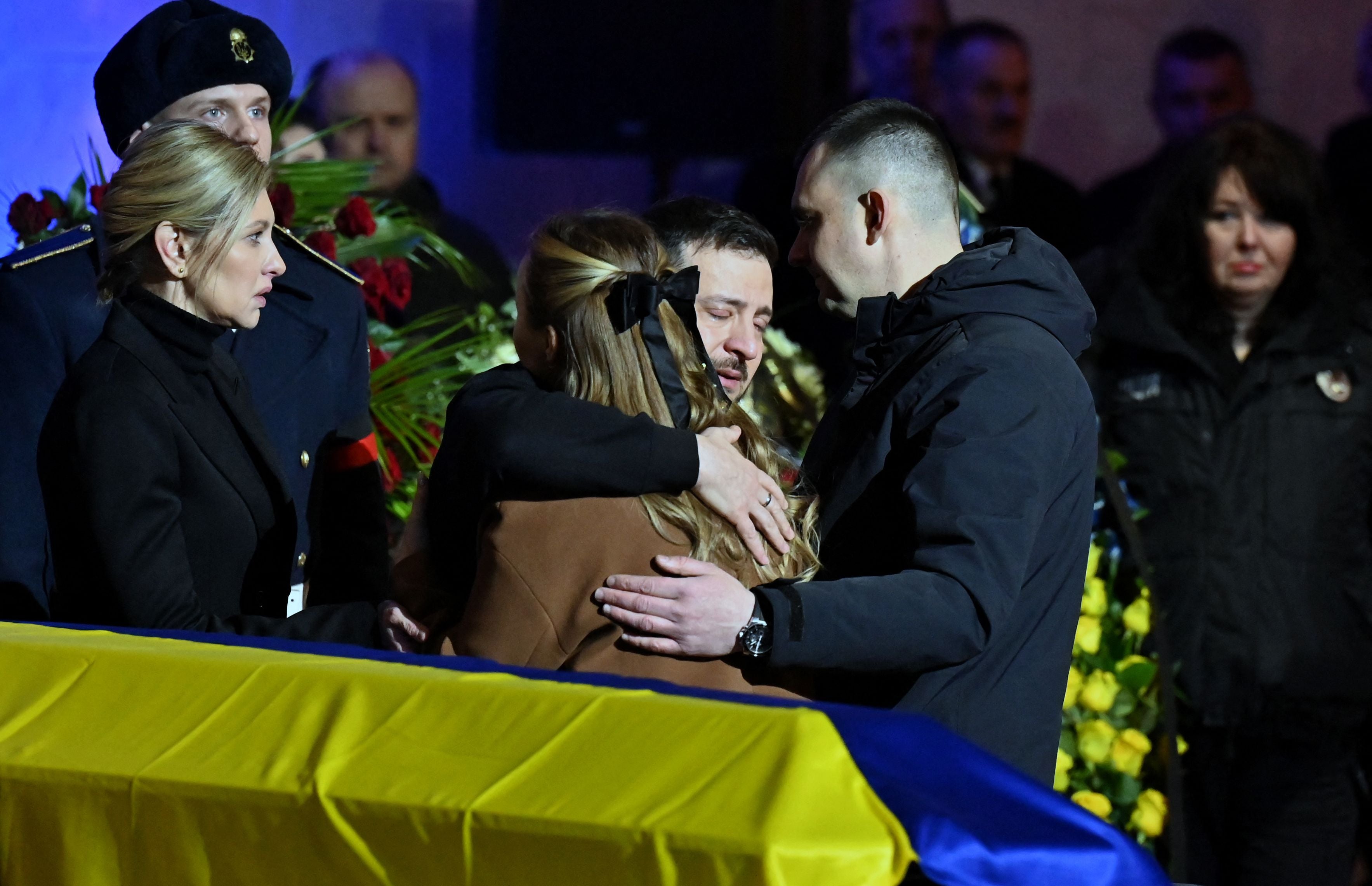 Ukrainian president Volodymyr Zelensky and his wife Olena offer relatives their condolences during the funeral ceremony of Ukrainian interior minister Denys Monastyrsky