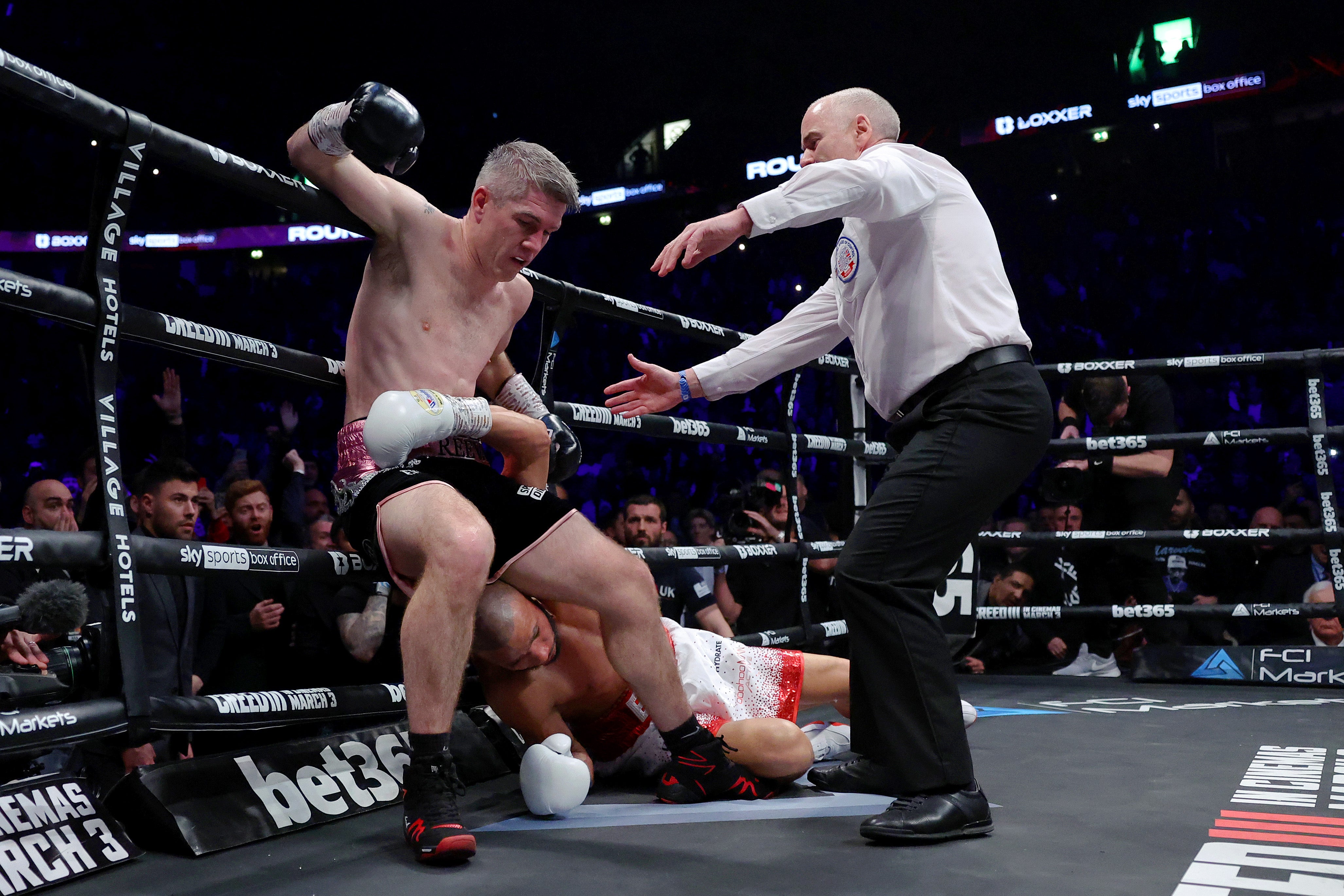 Eubank Jr slumps to the mat amid a second knockdown by Smith