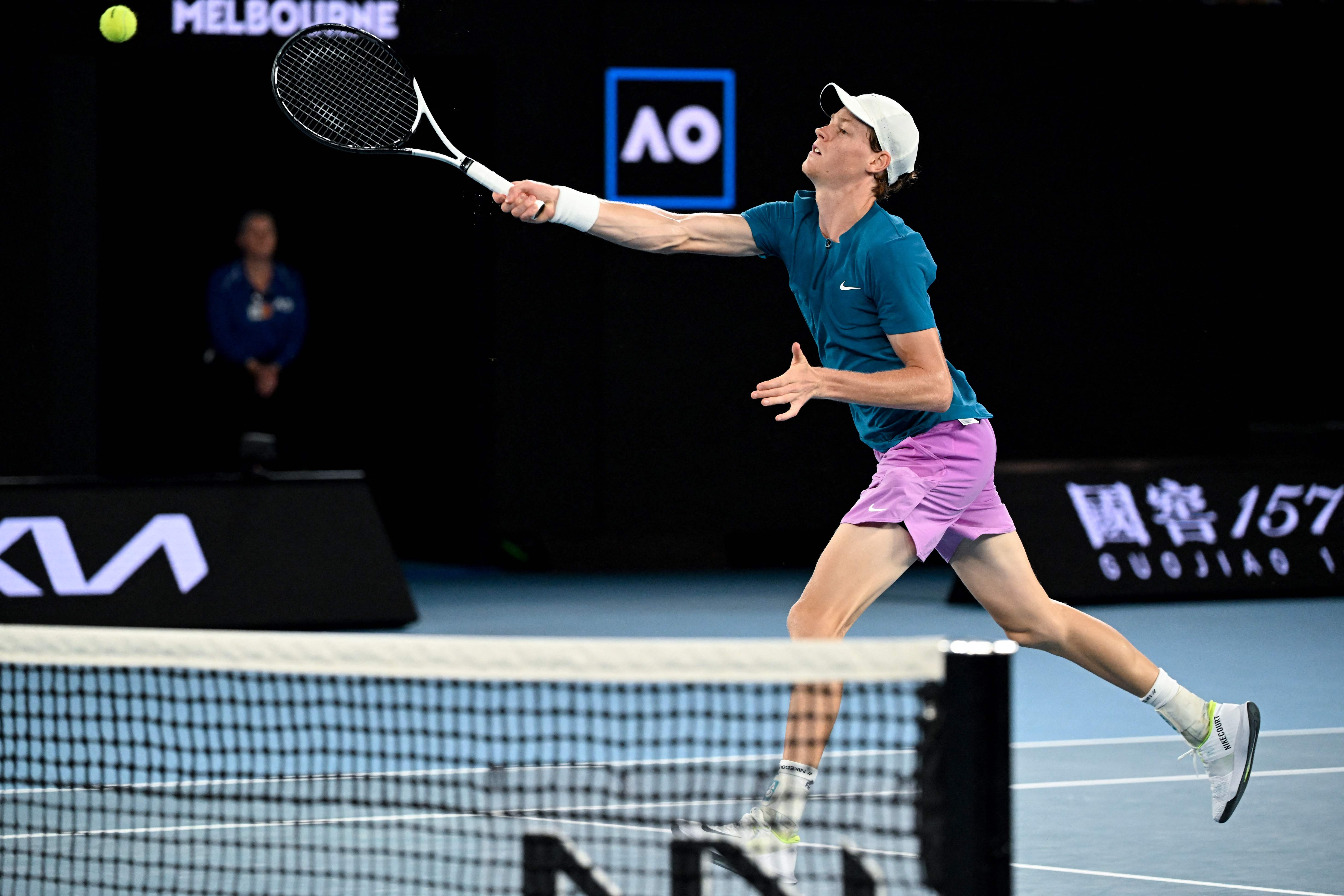 Jannik Sinner reaches for a volley at the net