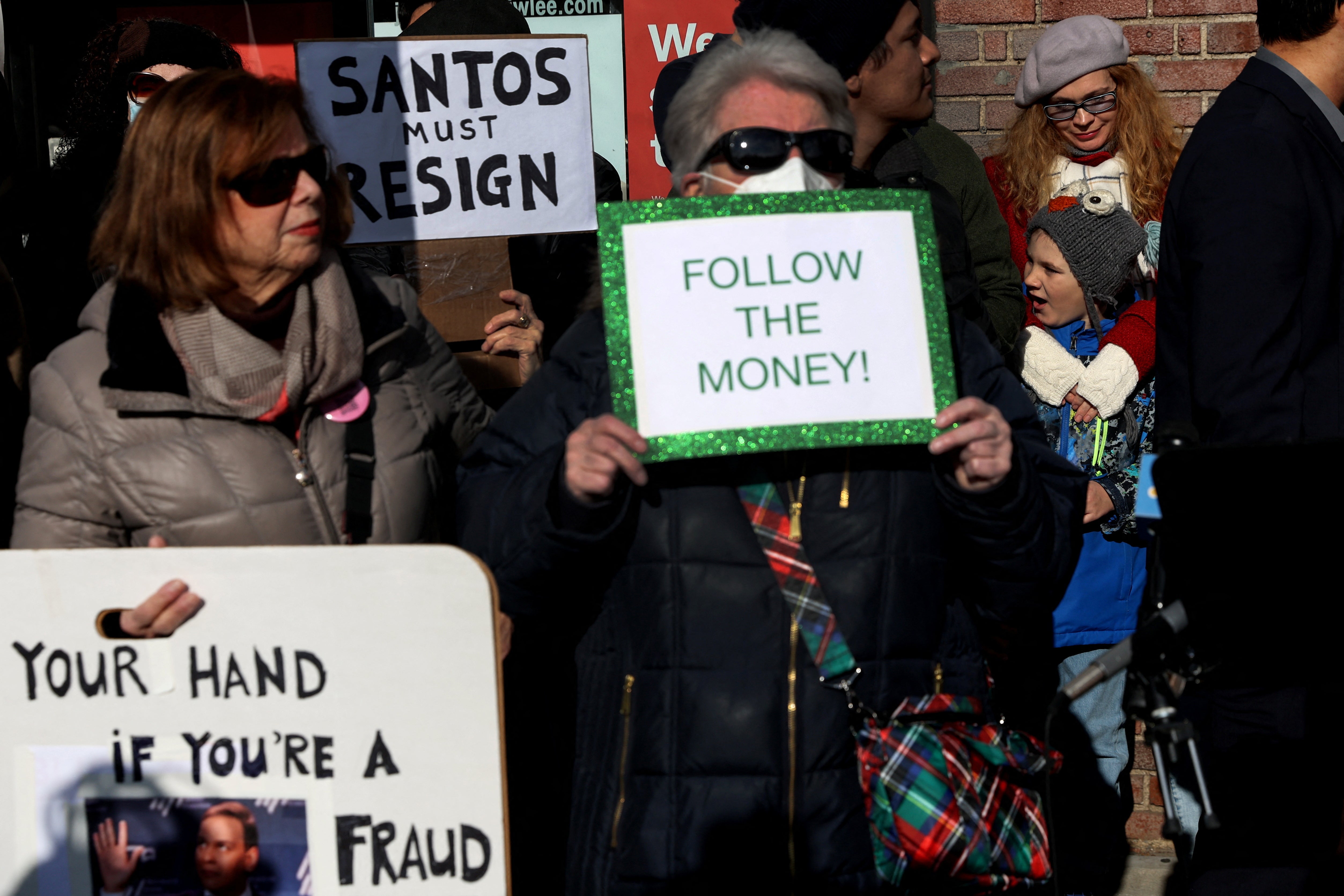 People demonstrate against newly elected freshman Rep. George Santos (R-NY), who is facing a scandal over his resume and claims he made on the campaign trail, outside a future campaign office in the Queens borough of New York City, U.S., January 7, 2023.