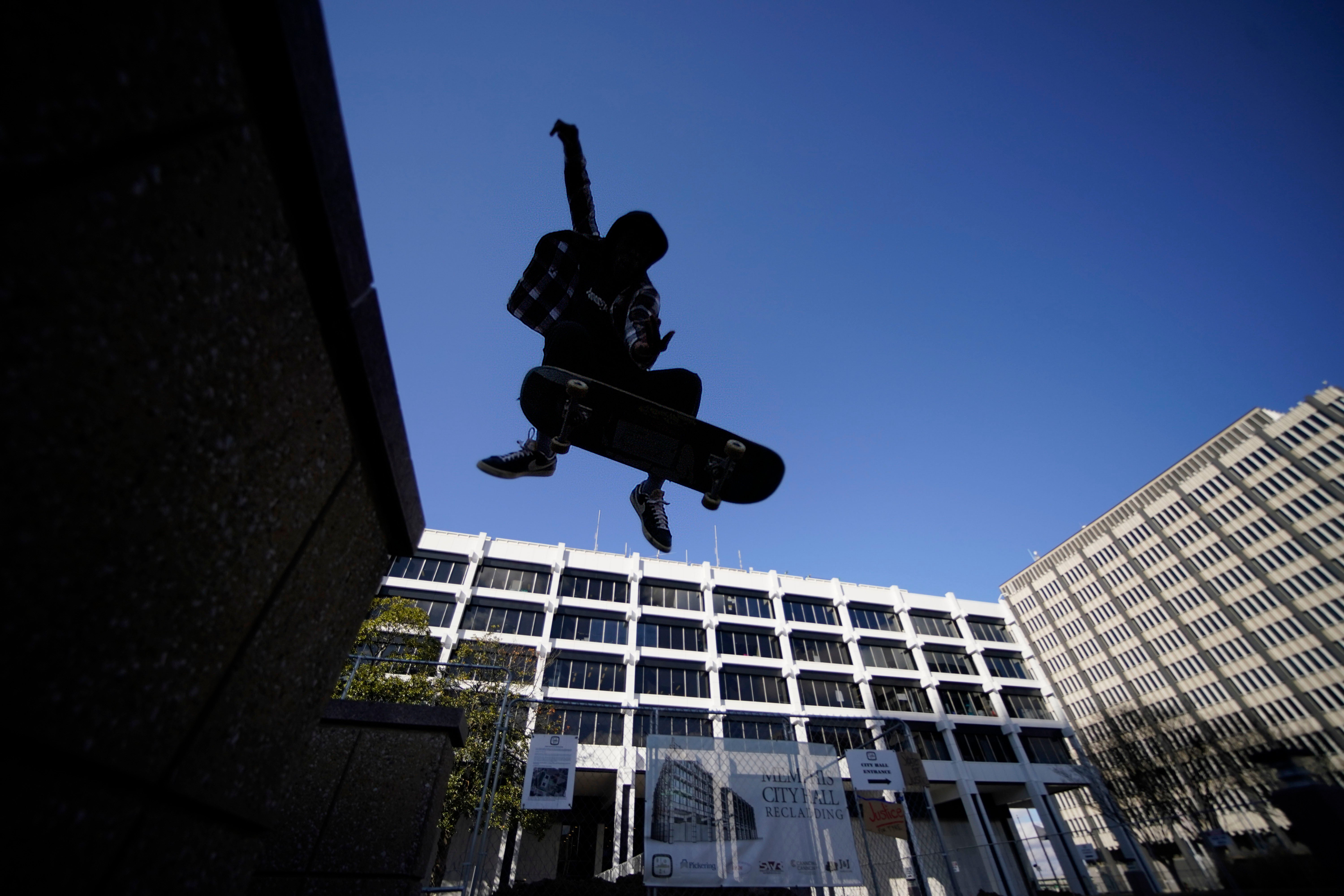 Skateboarder Kam Blakely skates in front of city hall in remembrance of Tyre Nichols