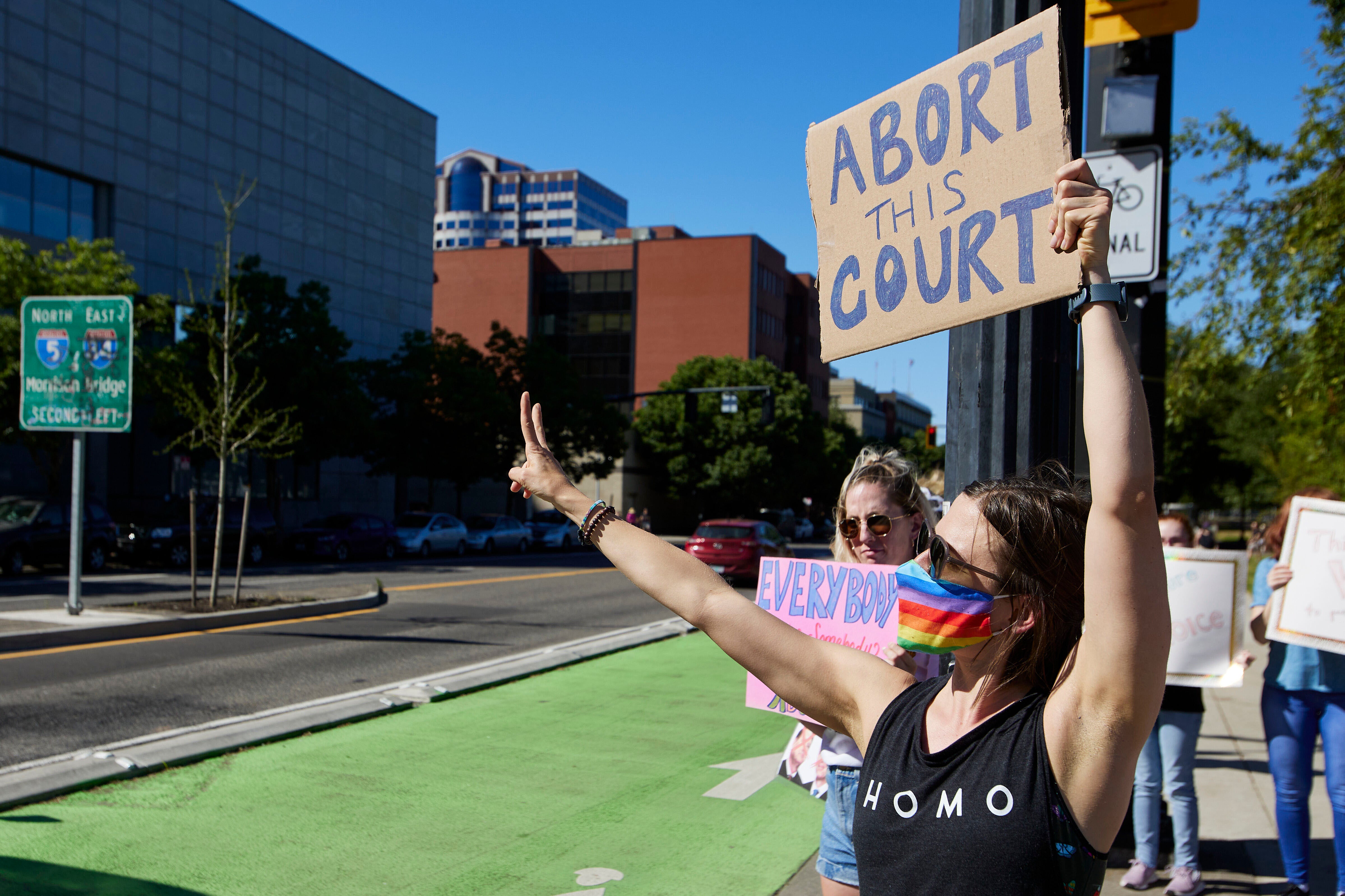 A protestor holds a sign saying ‘abort the court’ after the Supreme Court overturned Roe v. Wade