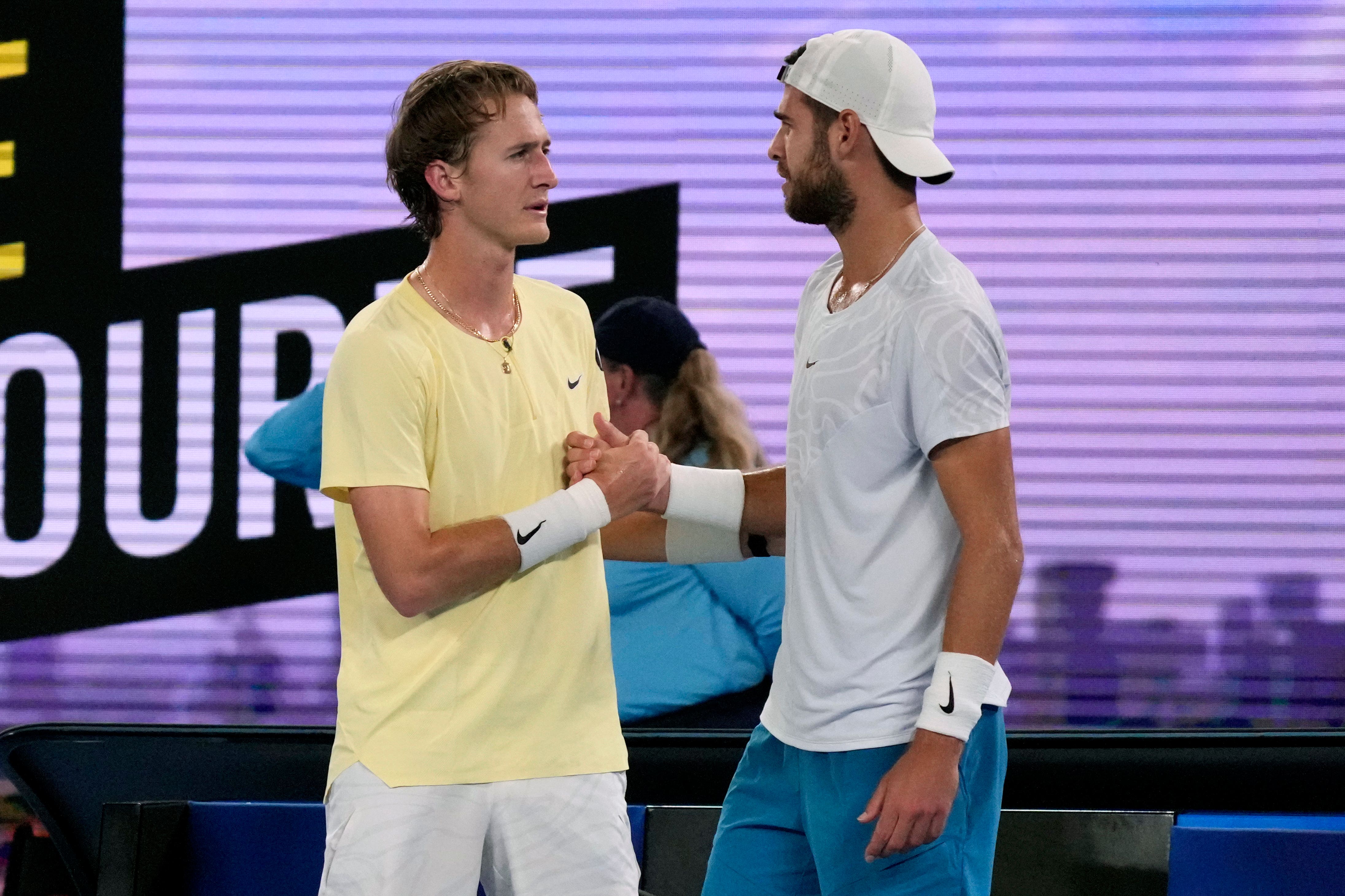 Karen Khachanov, right, shakes hands with Sebastian Korda following his retirement (Dita Alangkara/AP)