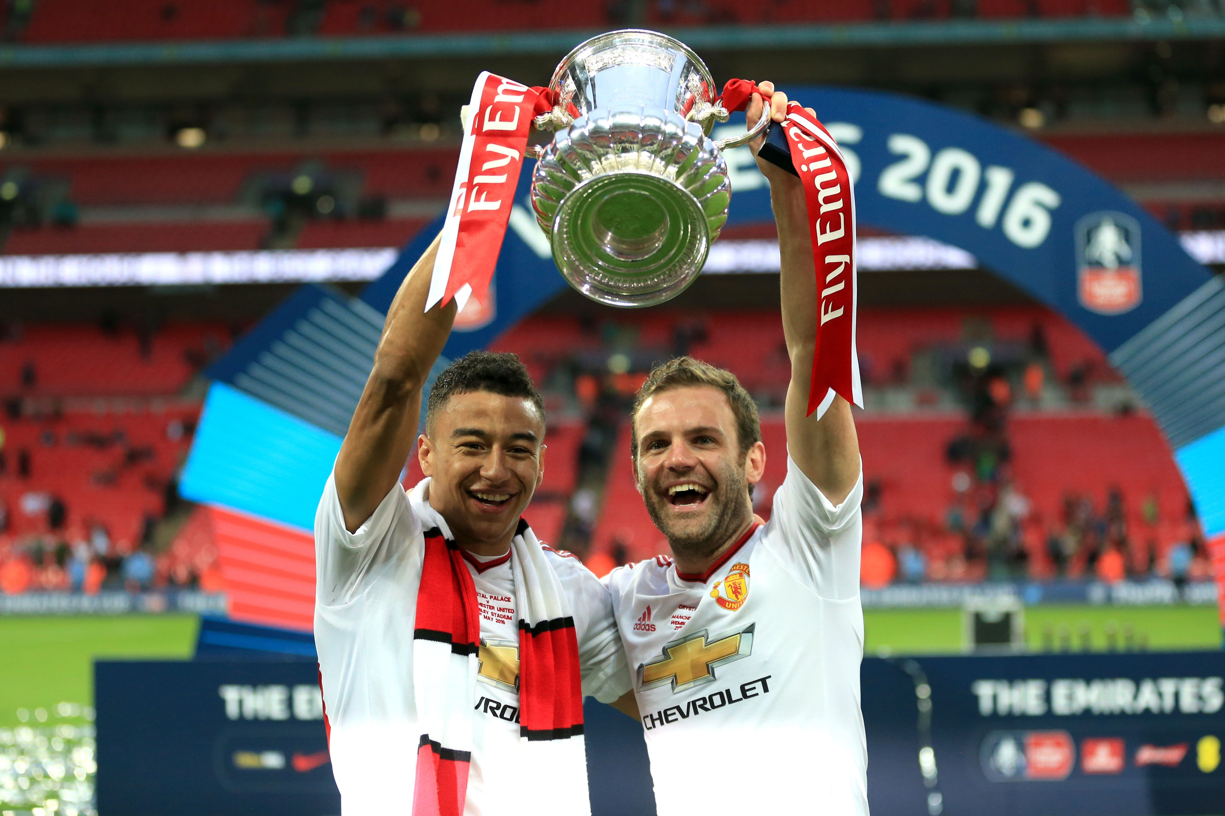 Juan Mata (right) travelled to Manchester United for a medical, on this day in 2014 (Mike Egerton/PA)