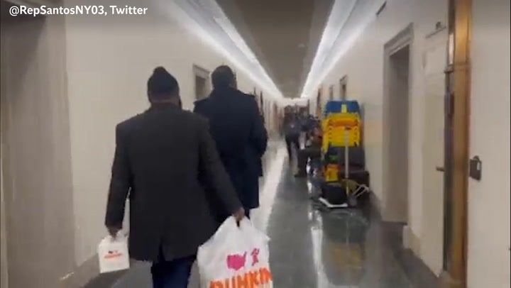 George Santos ‘surprises’ journalists waiting outside his office with Dunkin’ Donuts
