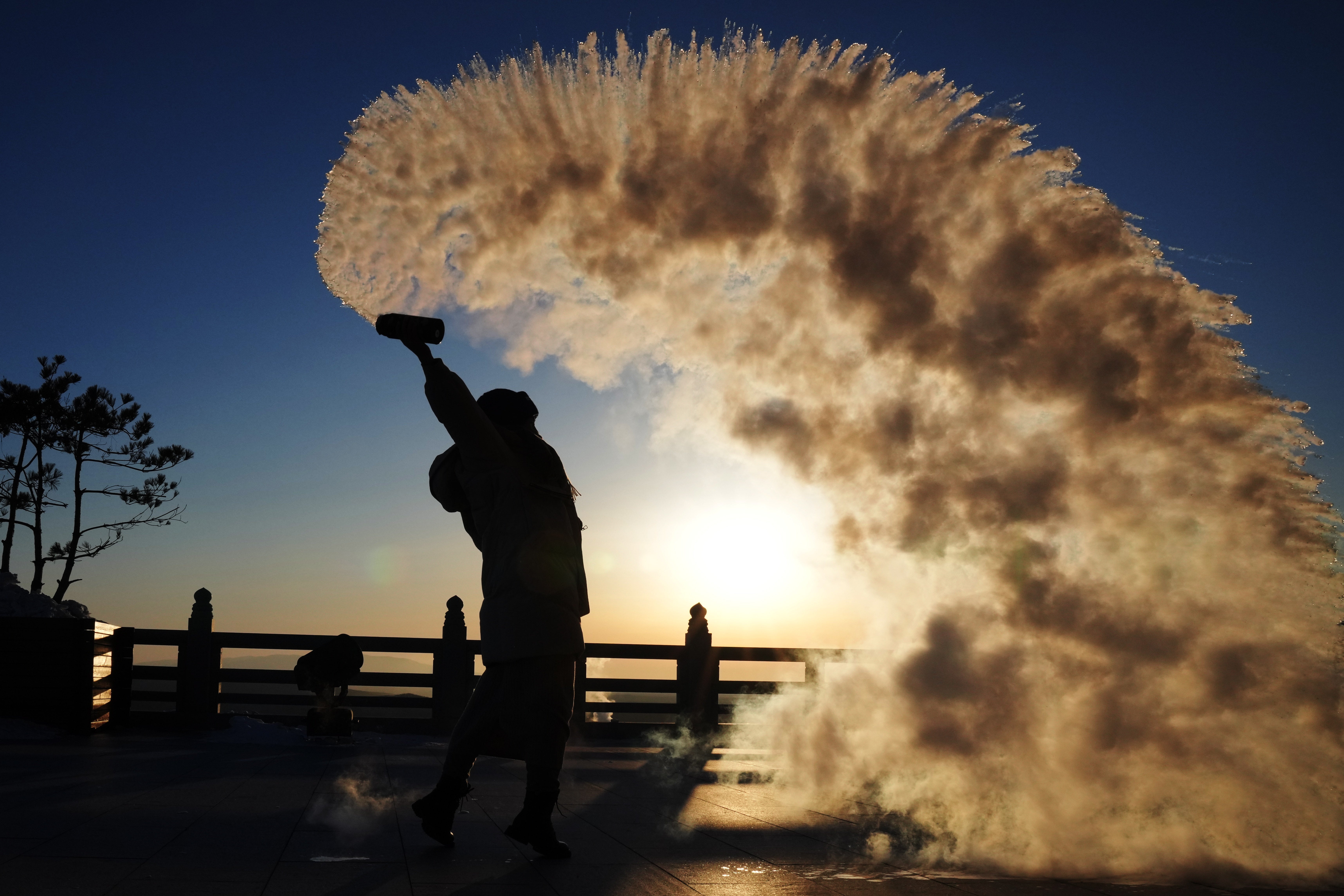 A tourist pours water in the air last week in Heilongjiang Province, China,