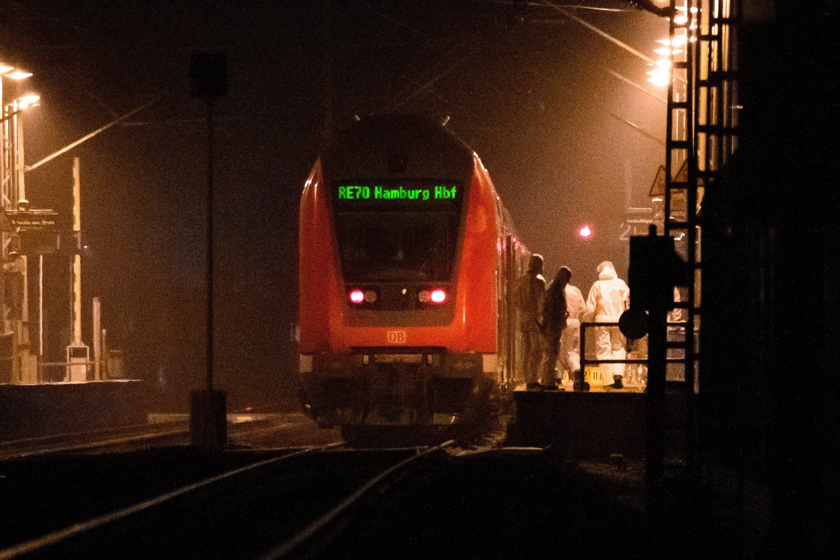 Forensics staff examine the train at Brokstedt station on Wednesday