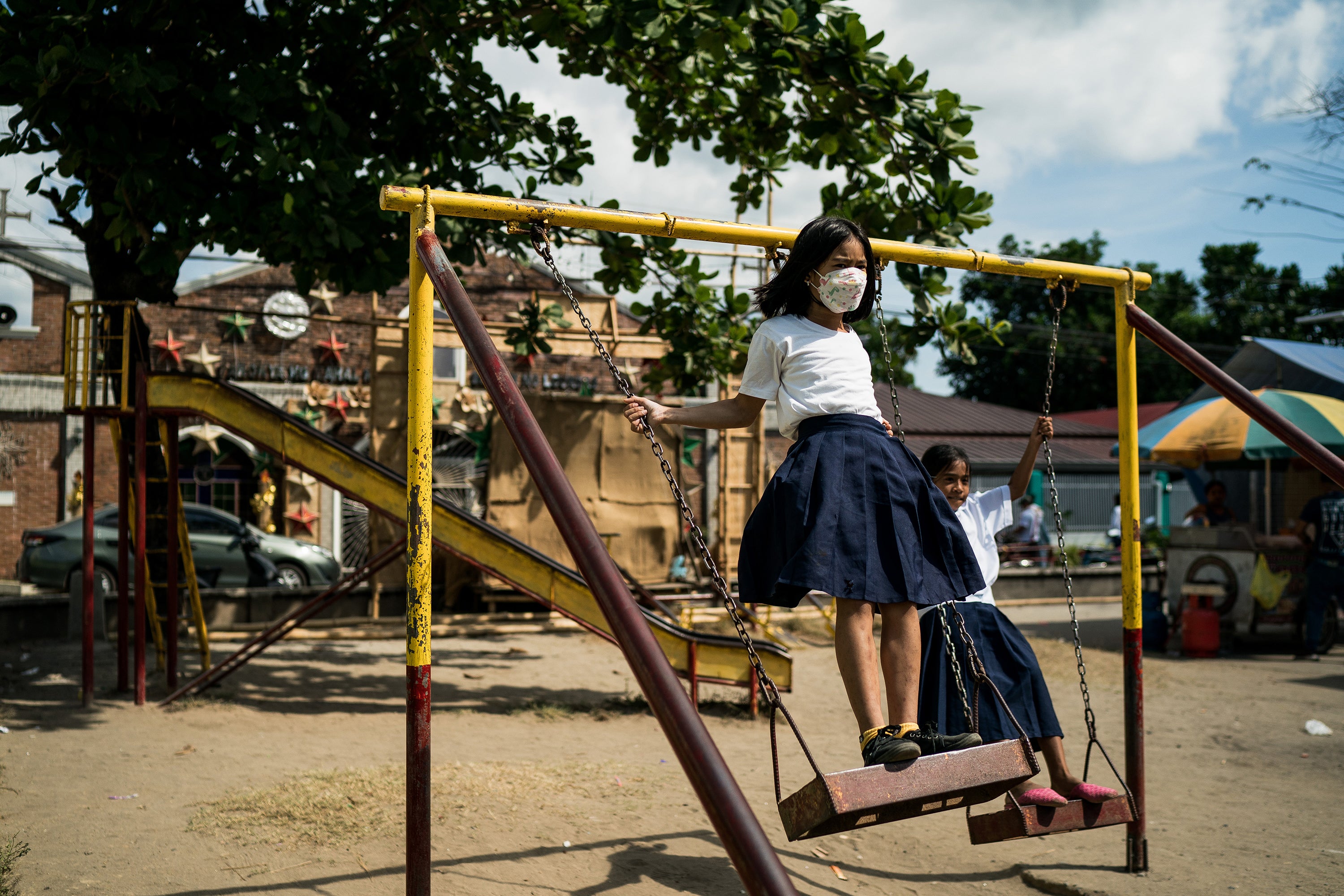 Girls play in a park in Nagbalayong, a village of 20,000 that sits about three miles from the nuclear plant