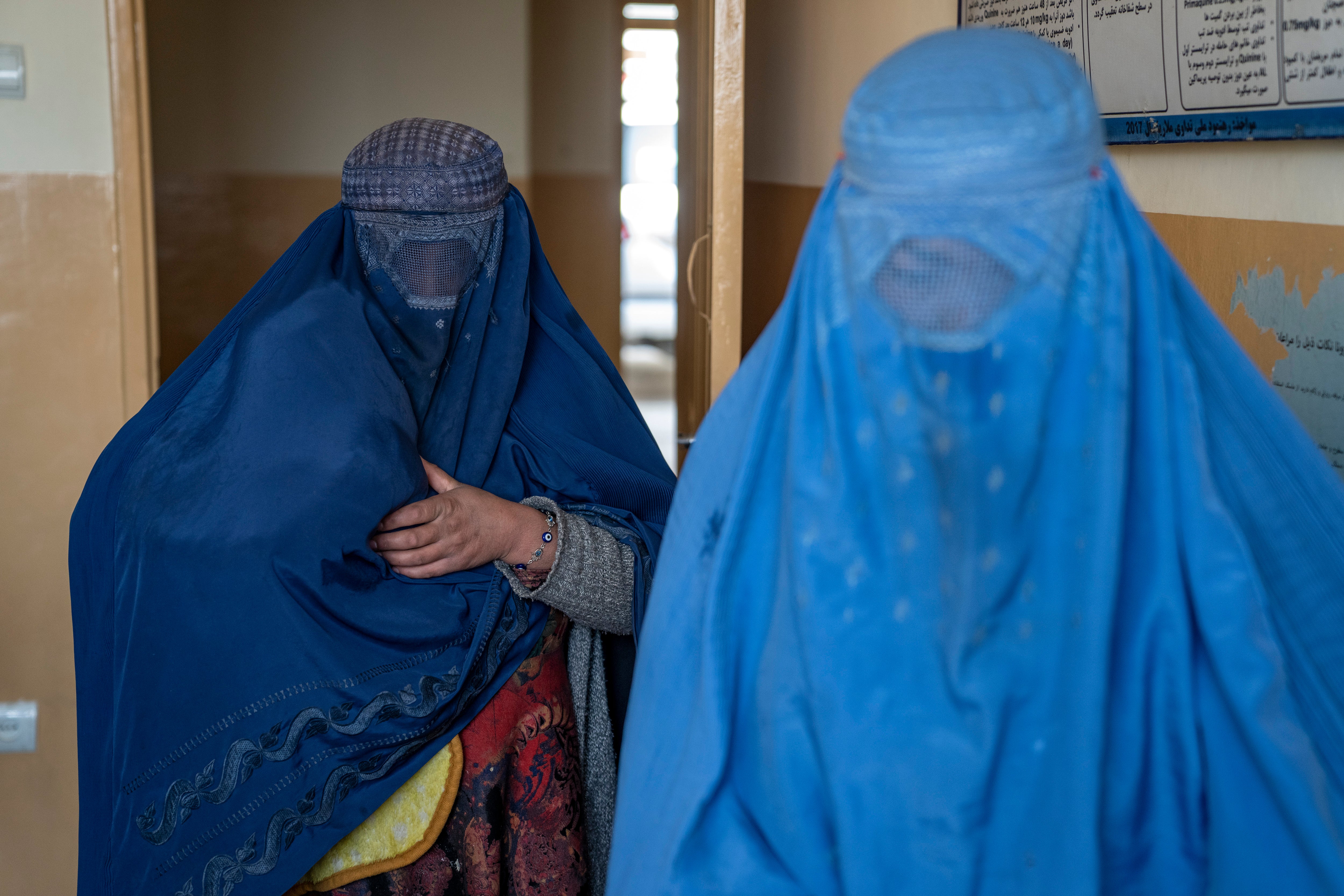 Mothers wait with their malnourished children to receive help at a clinic in Kabul