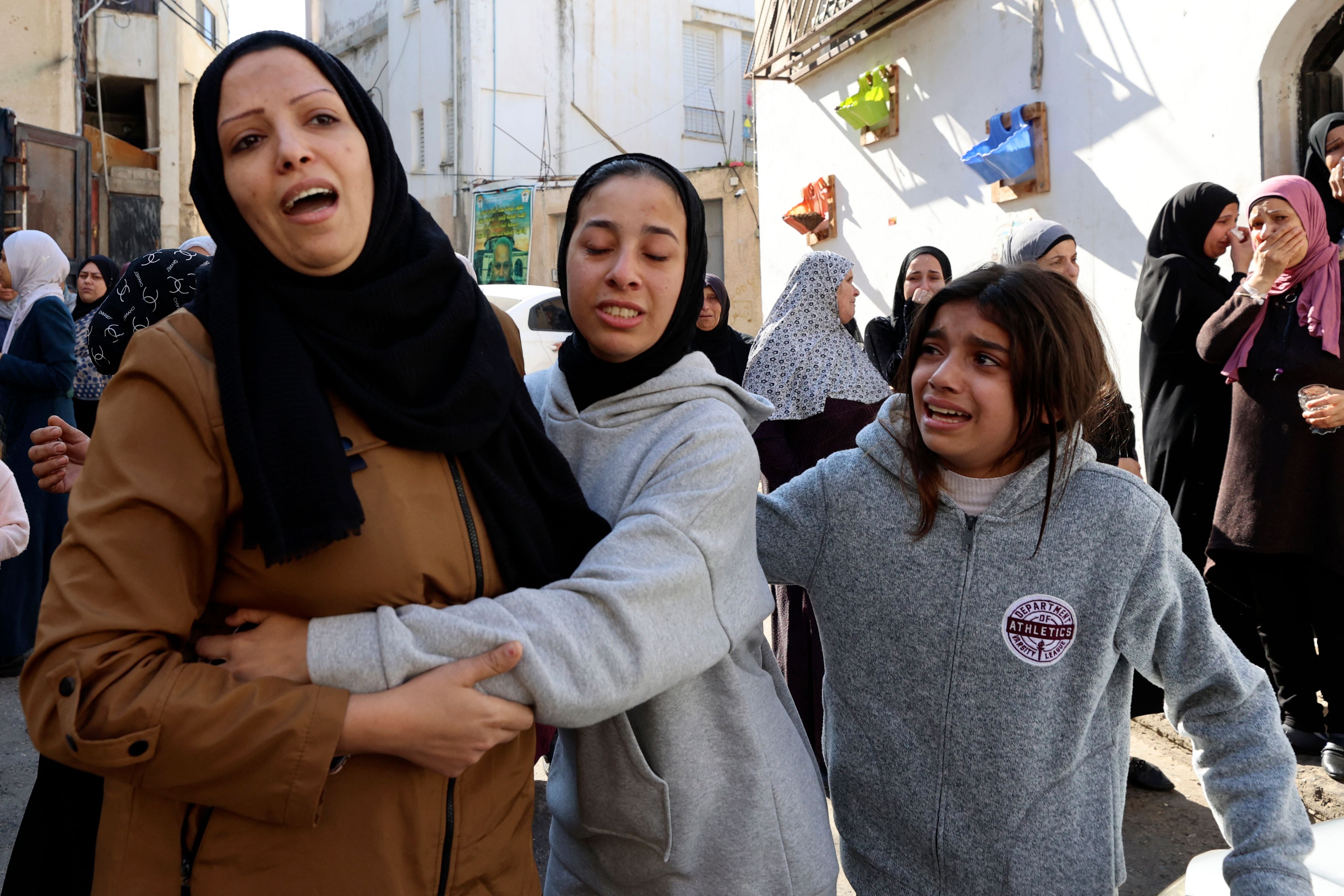 Relatives mourn the dead after the Israeli raid in Jenin