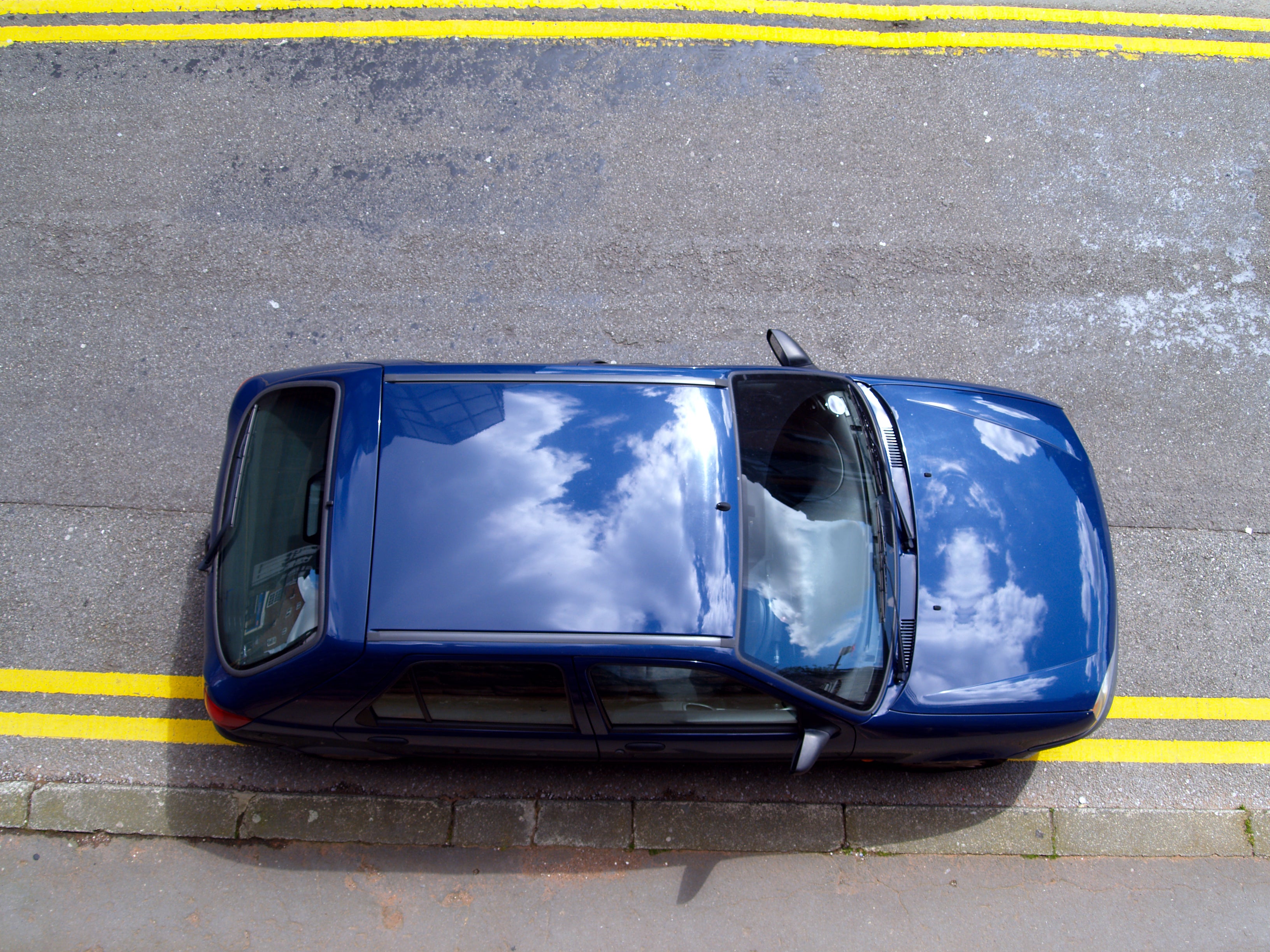 A car illegally parked on double yellow lines