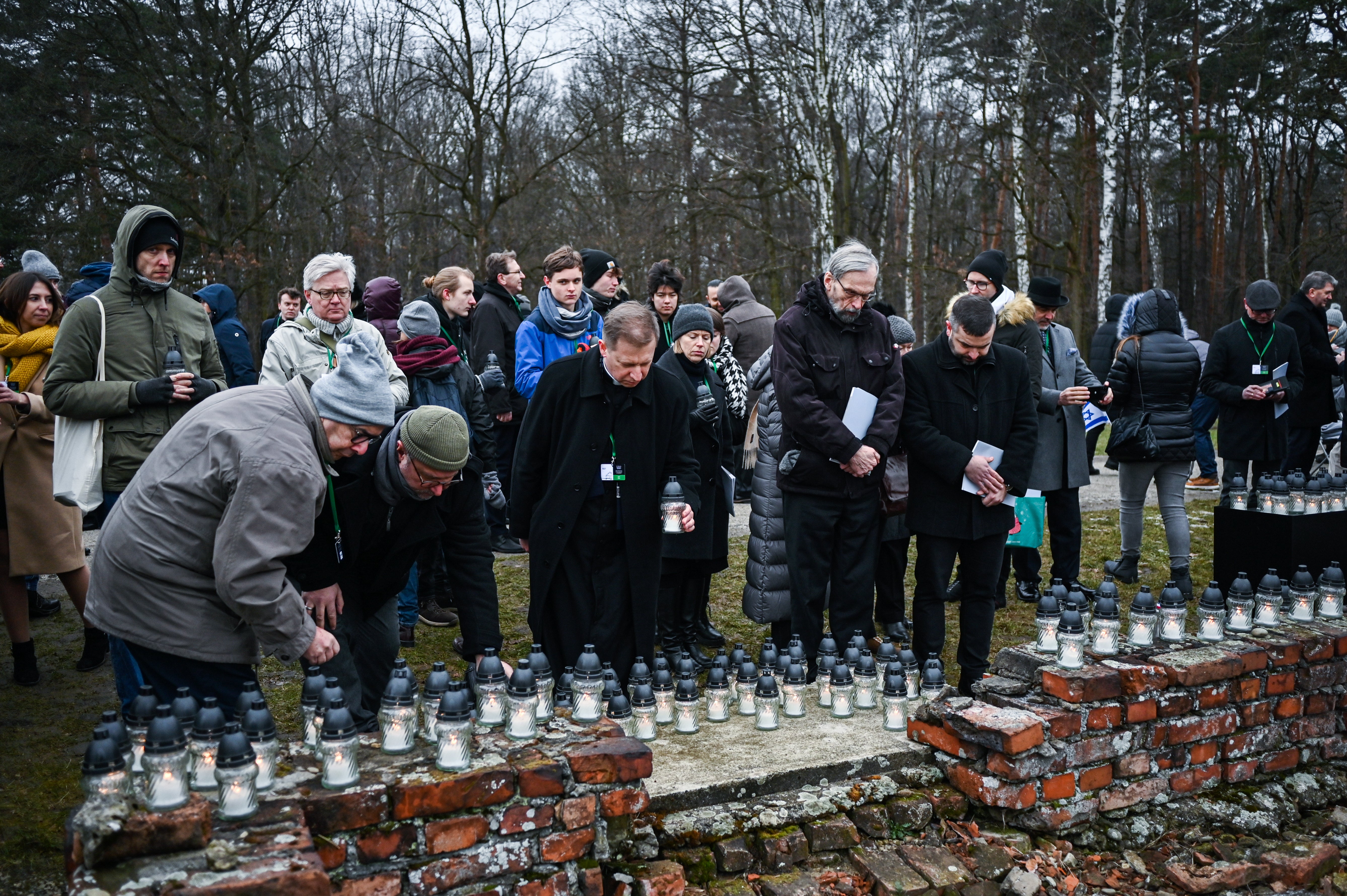 Candles are lit in the ruins of the Nazi camp Auschwitz-Birkenau