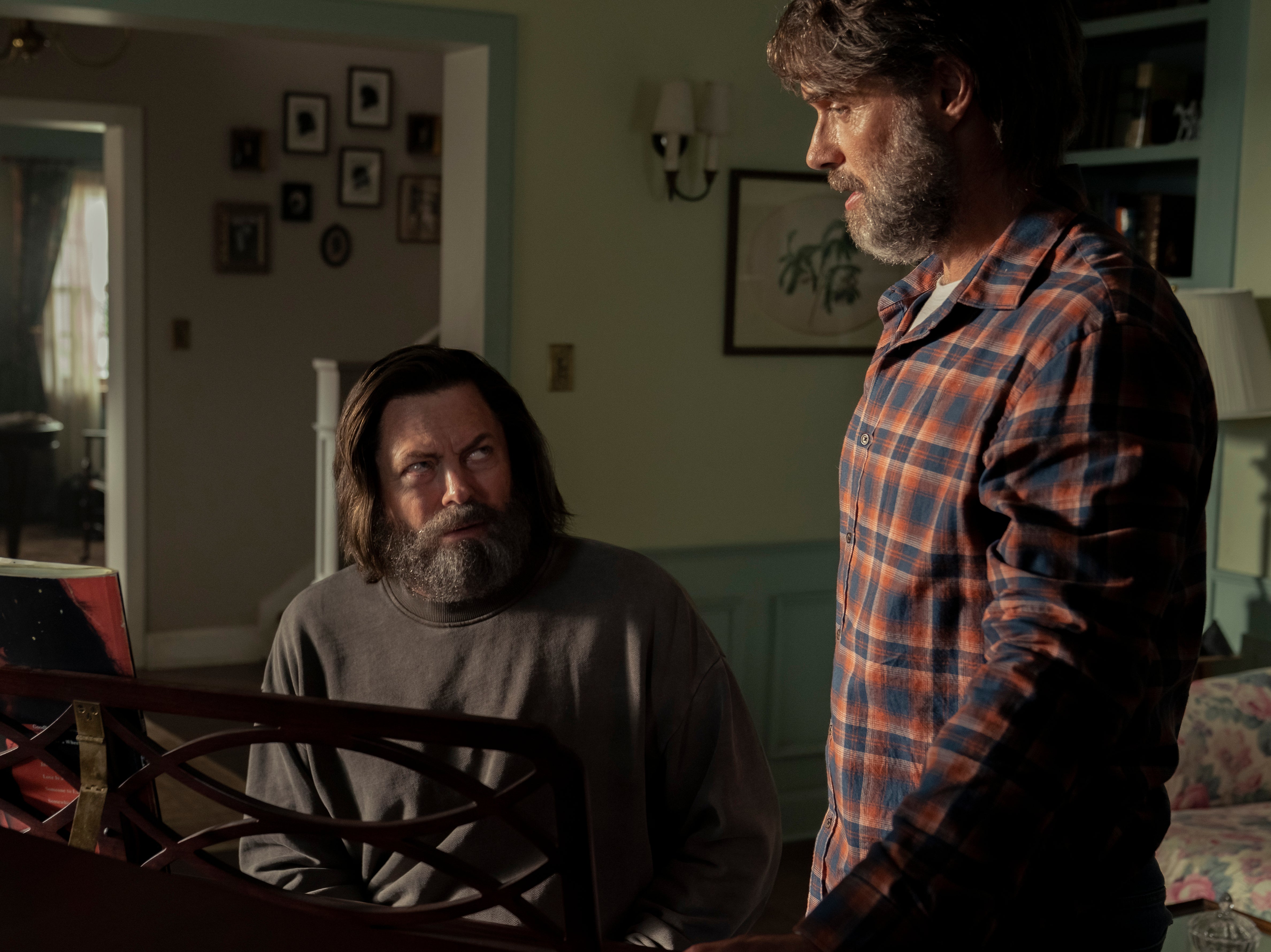 Nick Offerman sits and plays the piano while Murray Bartlett watches, in a particularly heart-wrenching scene from ‘The Last of Us'