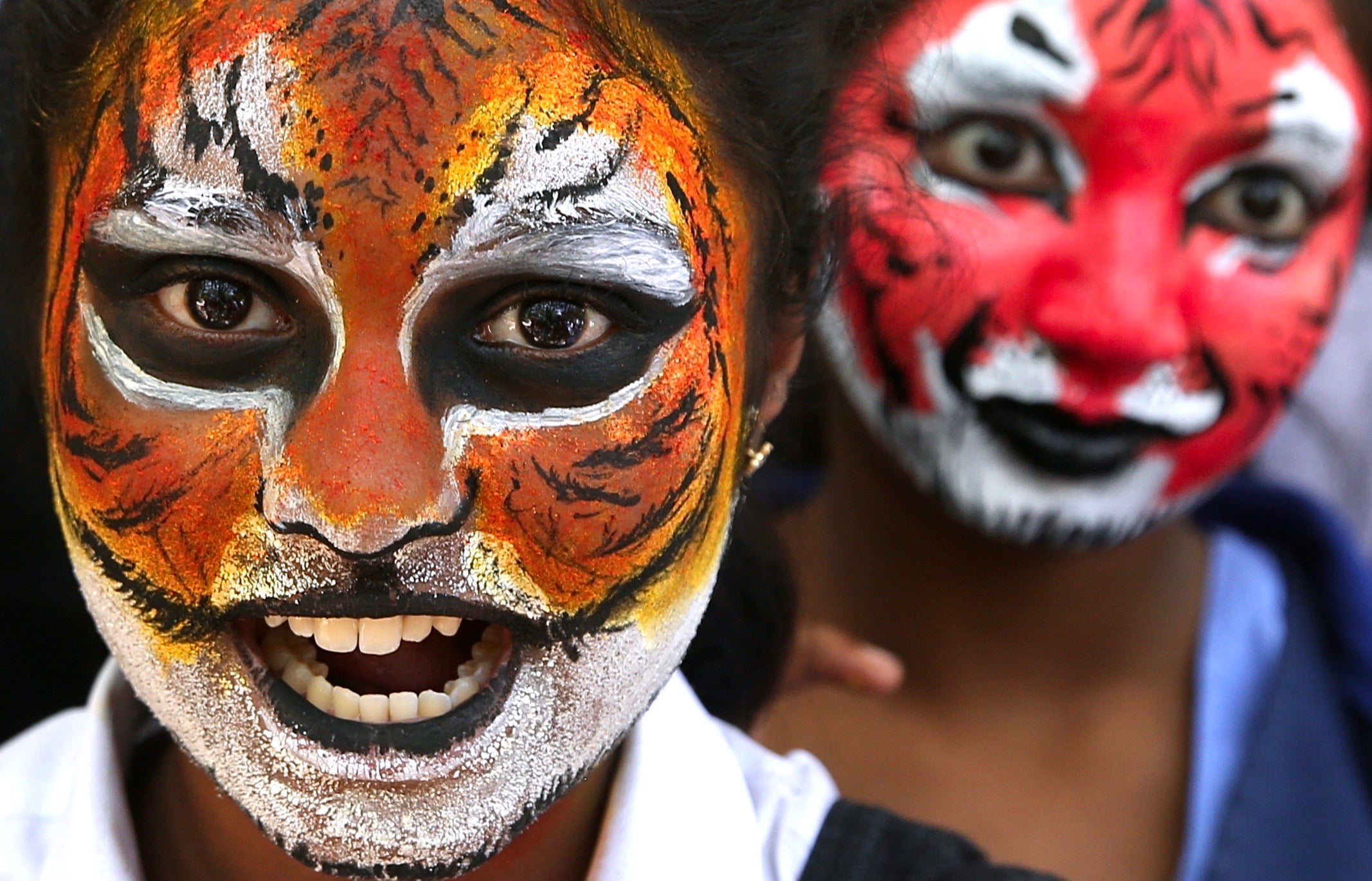 Schoolchildren with face paint resembling tigers take part in a 'Kids for Tigers' campaign in Bangalore, India