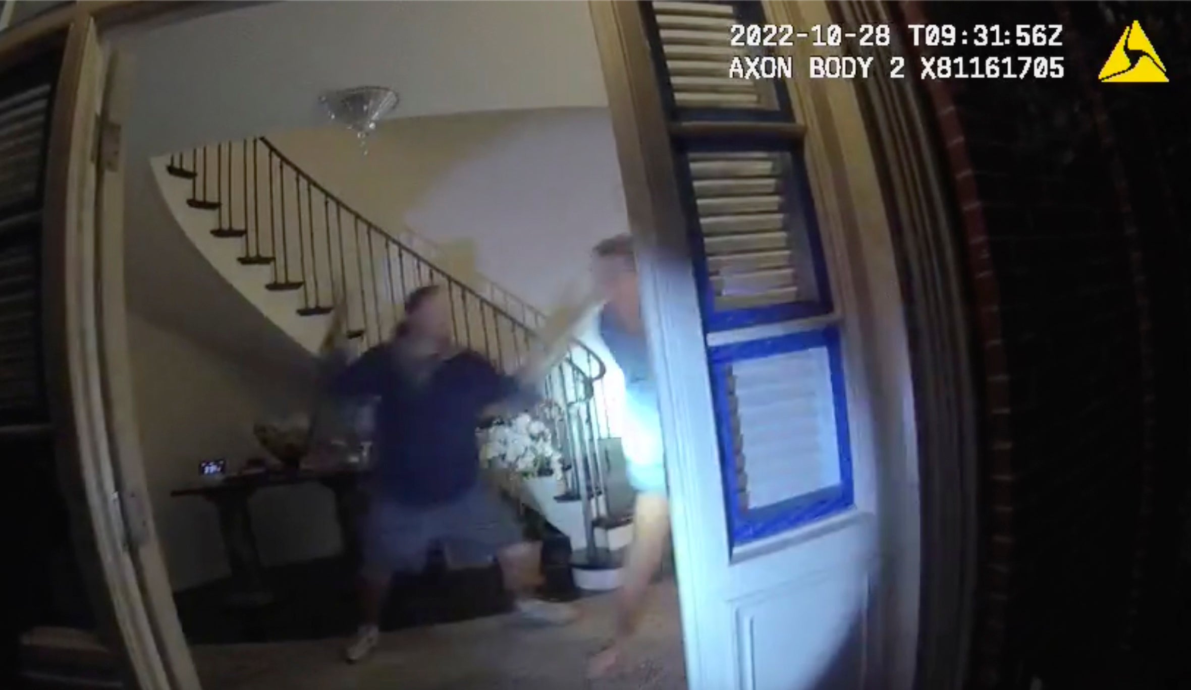 A screen grab from police bodycam footage shows Paul Pelosi and an intruder identified as David DePape