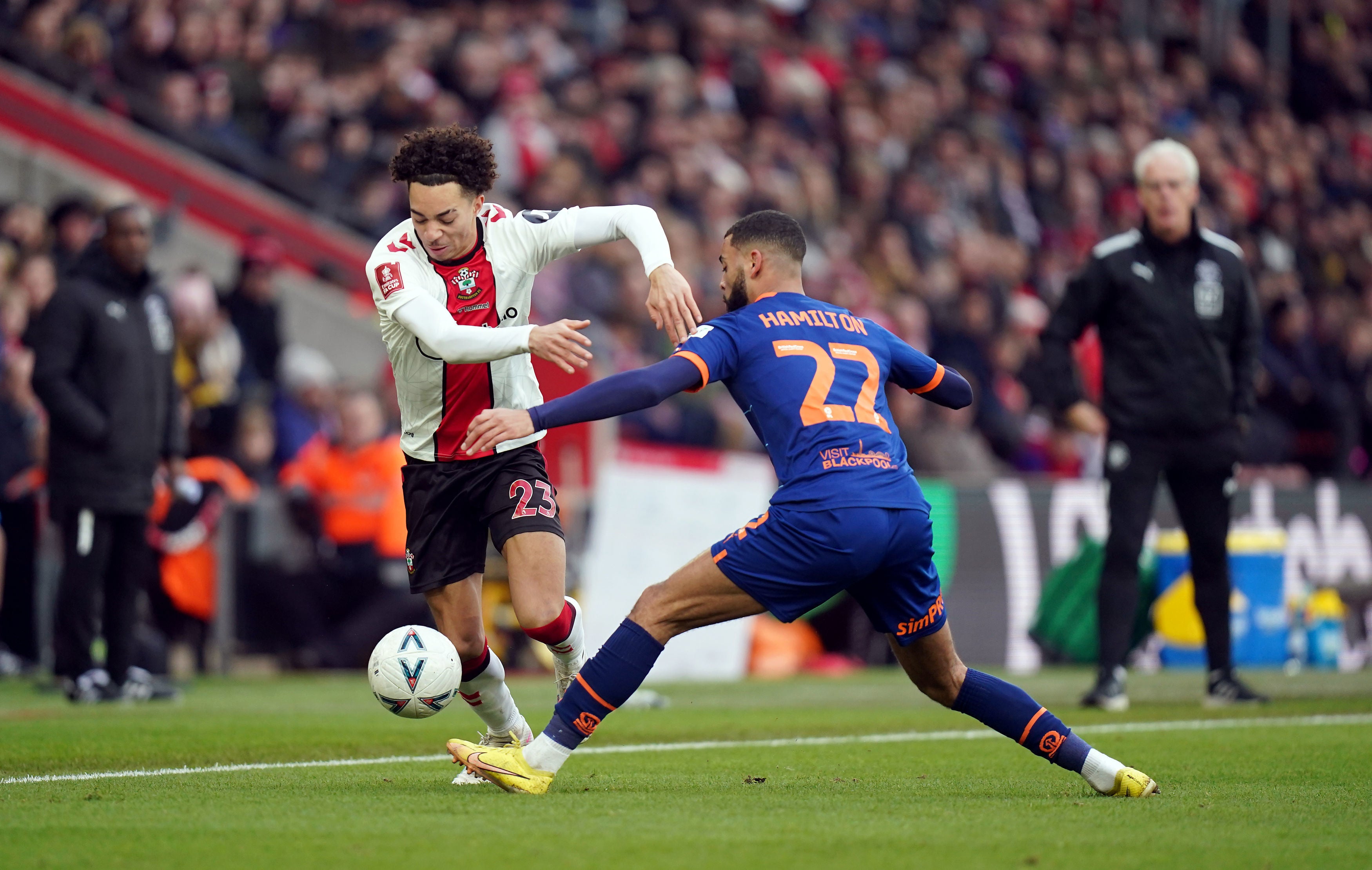 Southampton's Samuel Edozie and Blackpool's CJ Hamilton battle for the ball