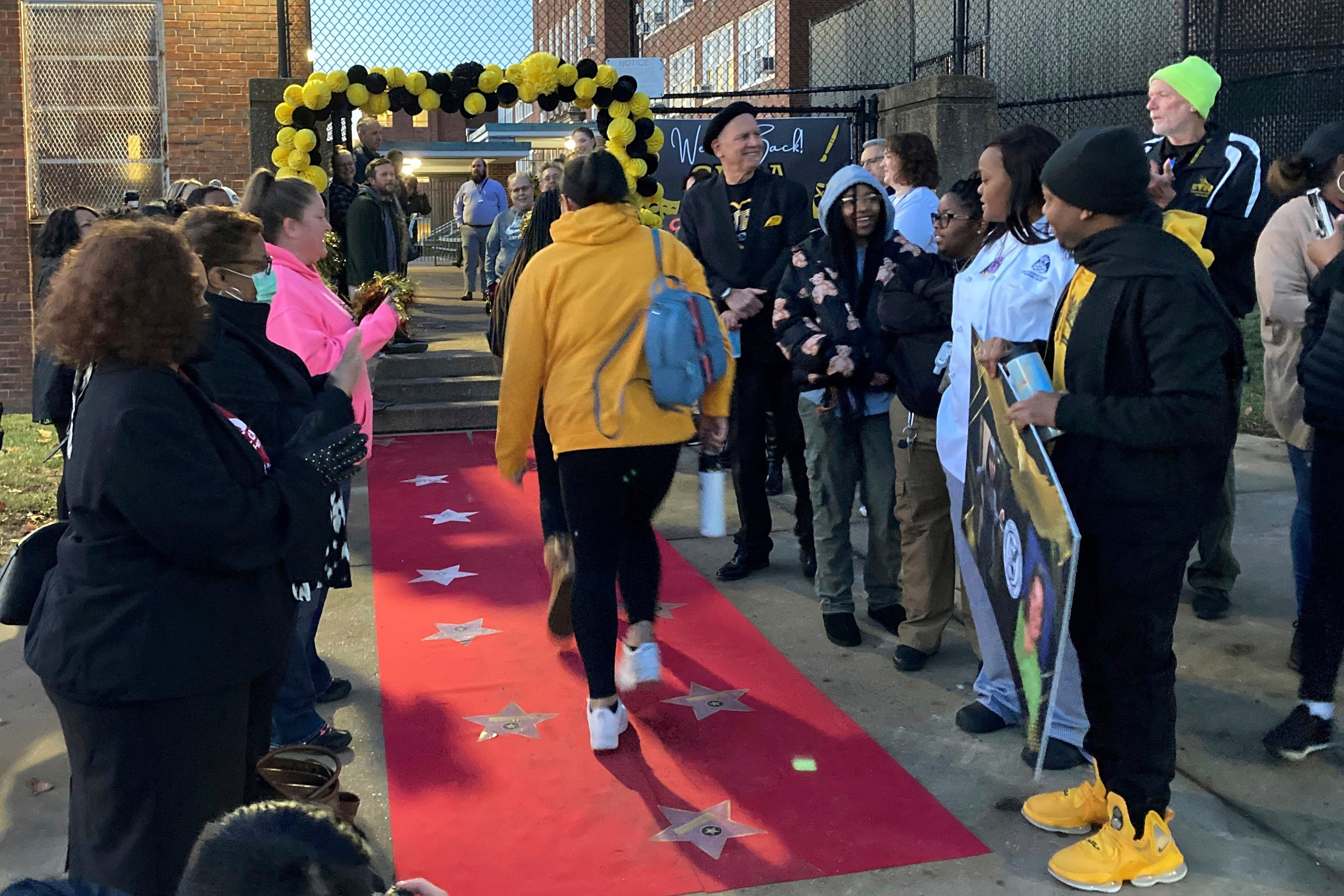 School staff cheer as students returned to in-person classes at Central Visual and Performing Arts High School in St. Louis on Jan. 17, 2023