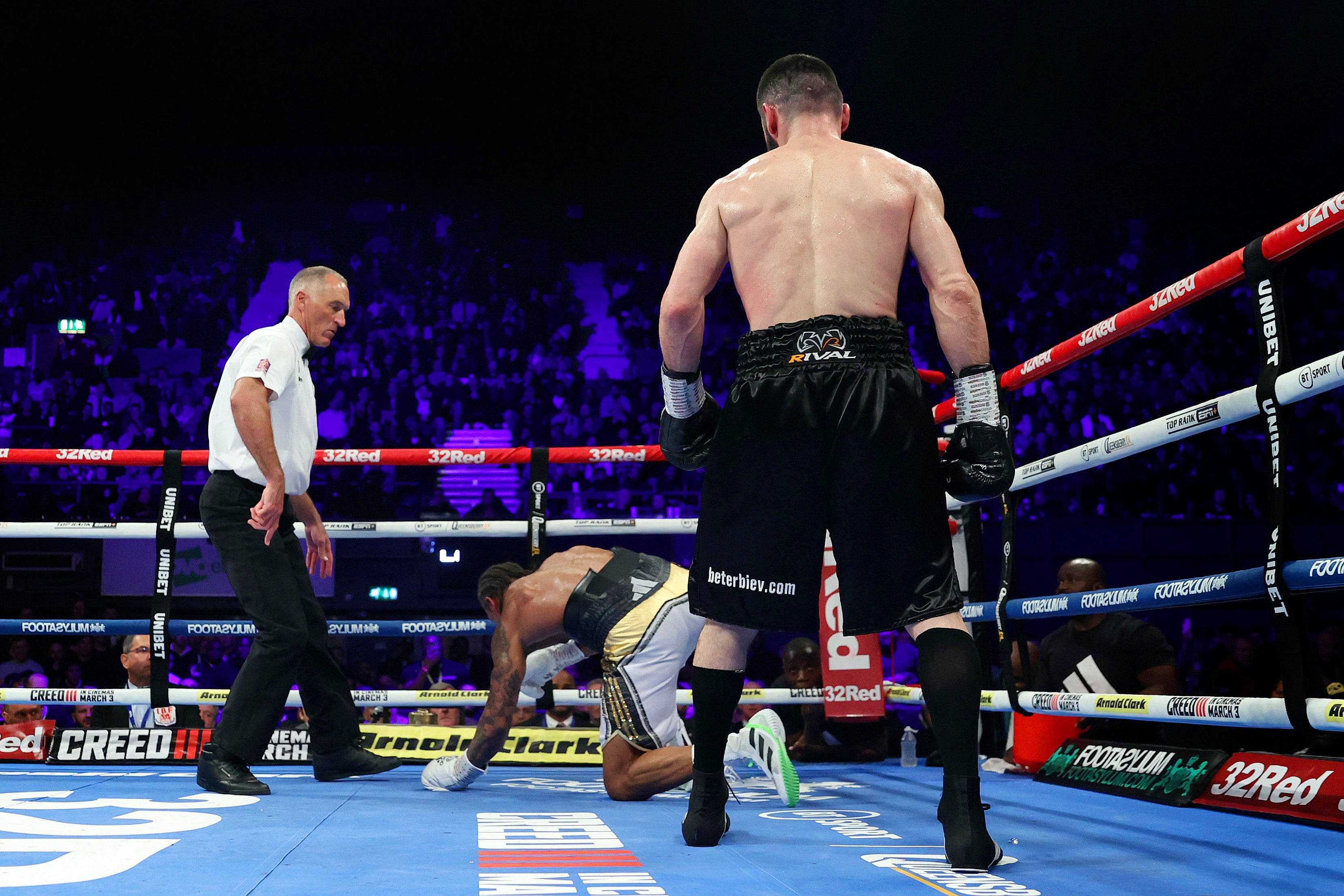 Beterbiev looks on as he walks back to his corner