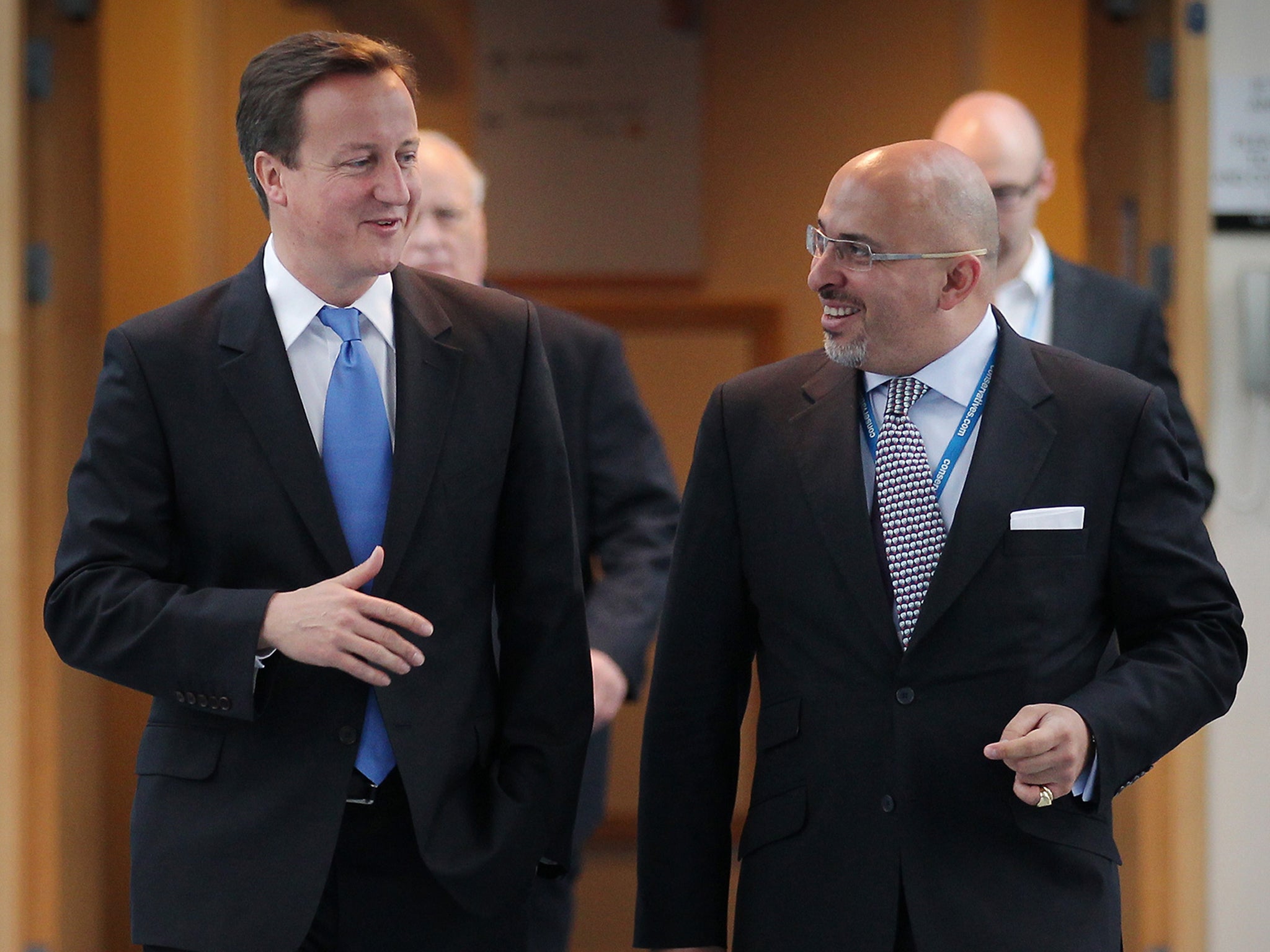 Prime minister David Cameron walks with Nadhim Zahawi at the Conservative Party conference during a television interview on 5 October 2010