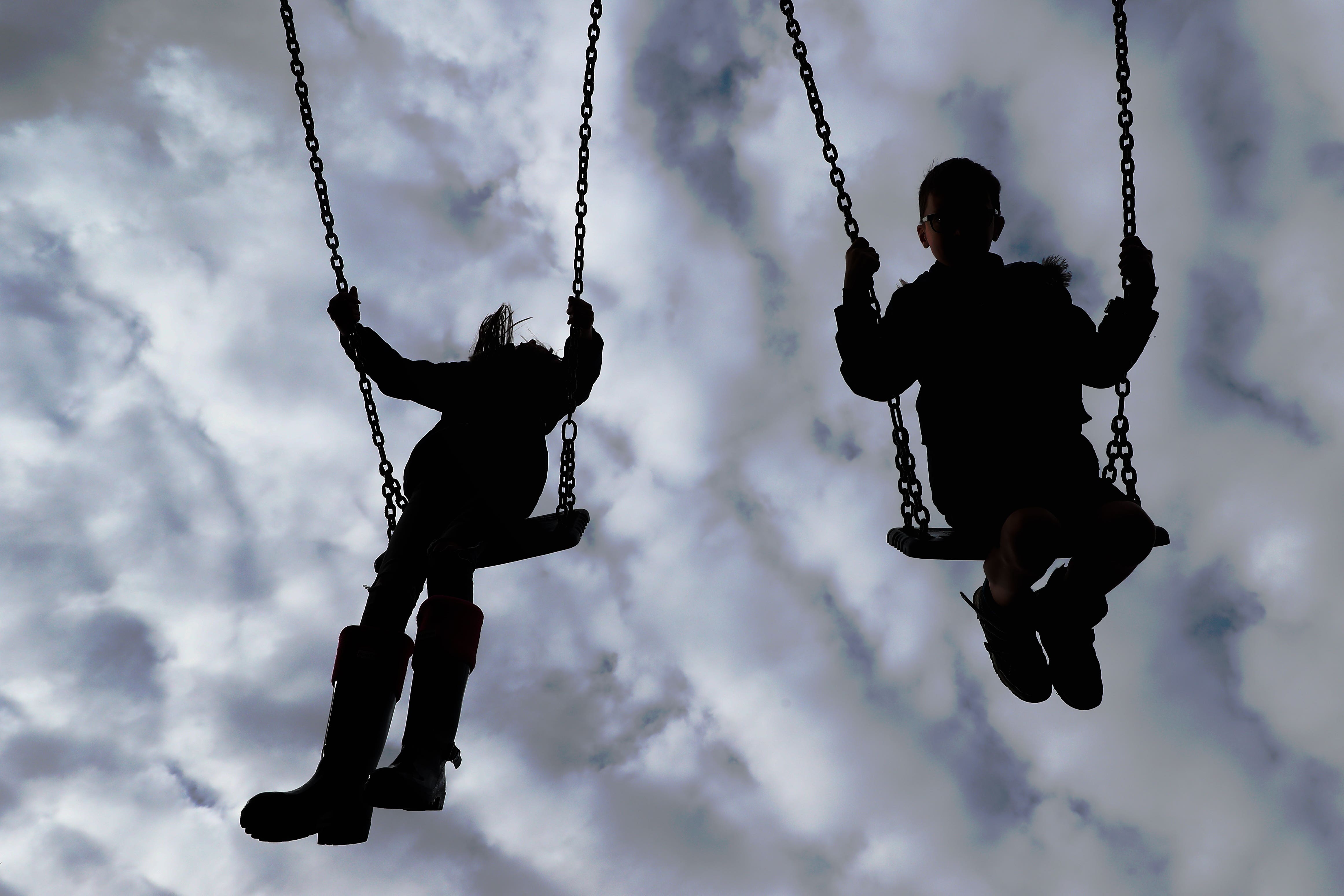 Children enjoy playing on swings in a park (Gareth Fuller/PA)