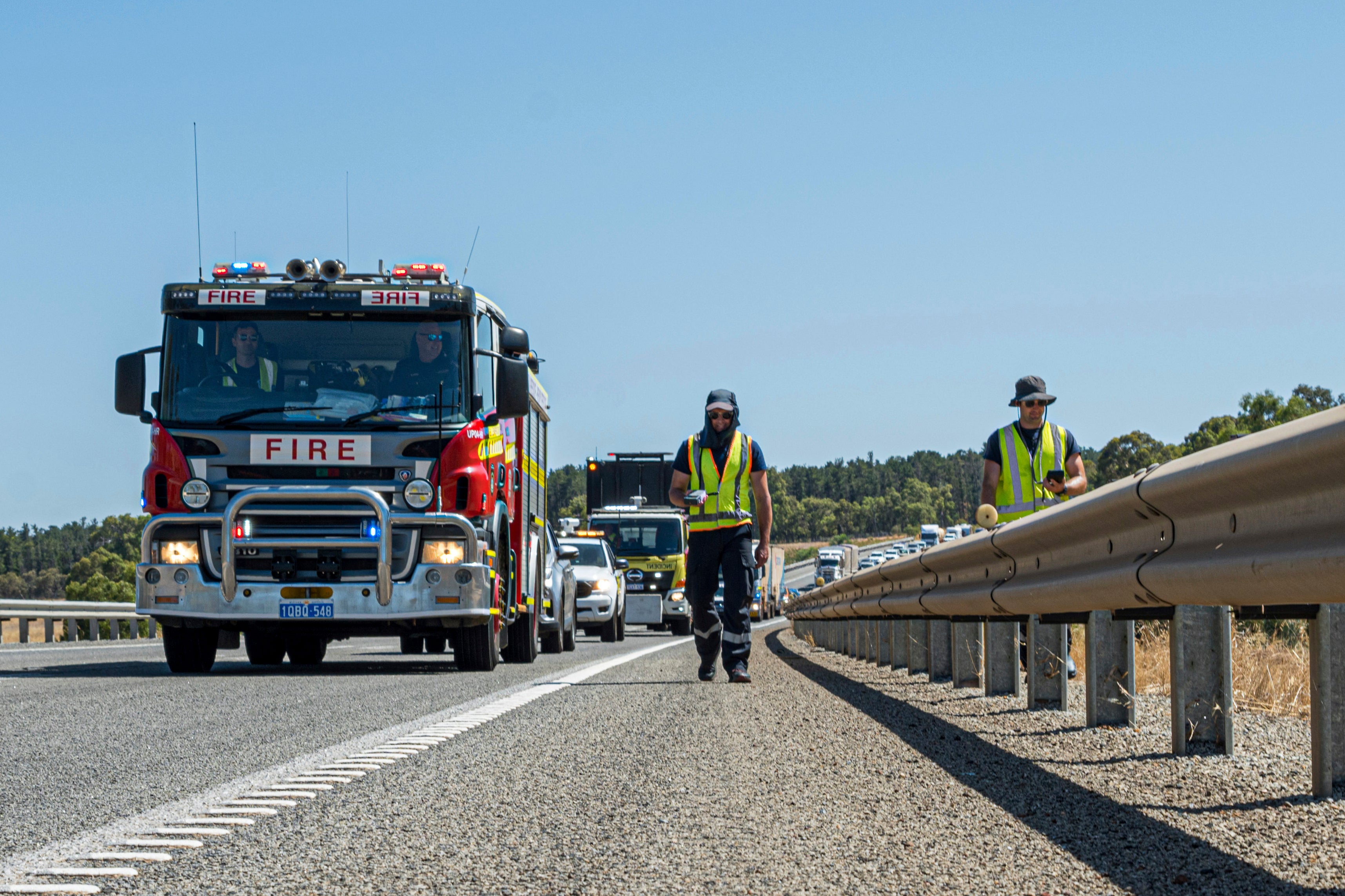 Emergency workers trudge along the Great National Highway with gamma detectors