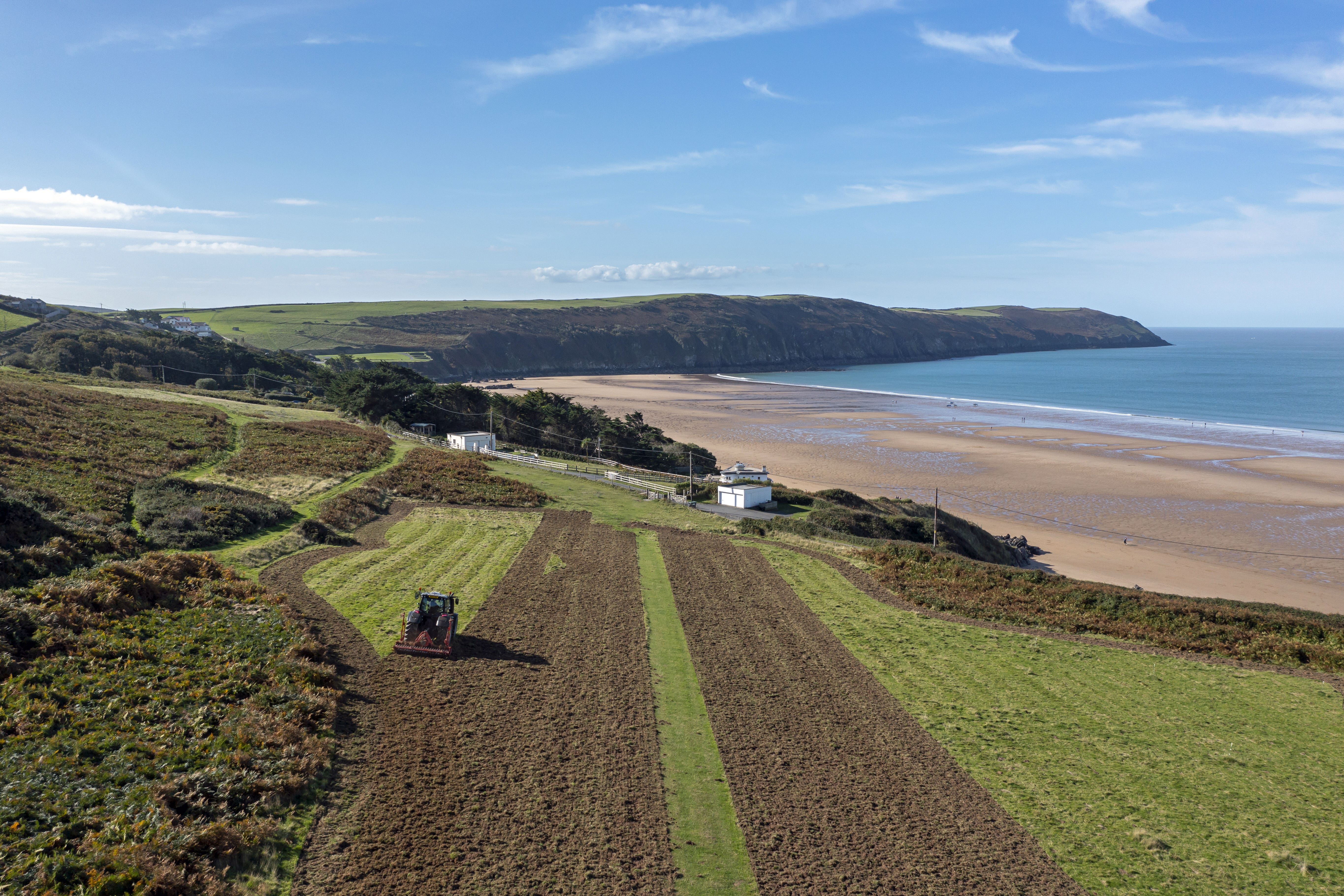 Undated handout photo issued by by National Trust of grasslands near Woolacombe in north Devon being prepared as the largest ever wildflower grassland in the UK is to be created by the National Trust. The project will see pockets of a rich savannah sown across 70 miles of the north Devon landscape by 2030. In the past few weeks, the National Trust has planted 1.3 million tonnes of seed across 86 hectares of land. Issue date: Thursday November 3, 2022.