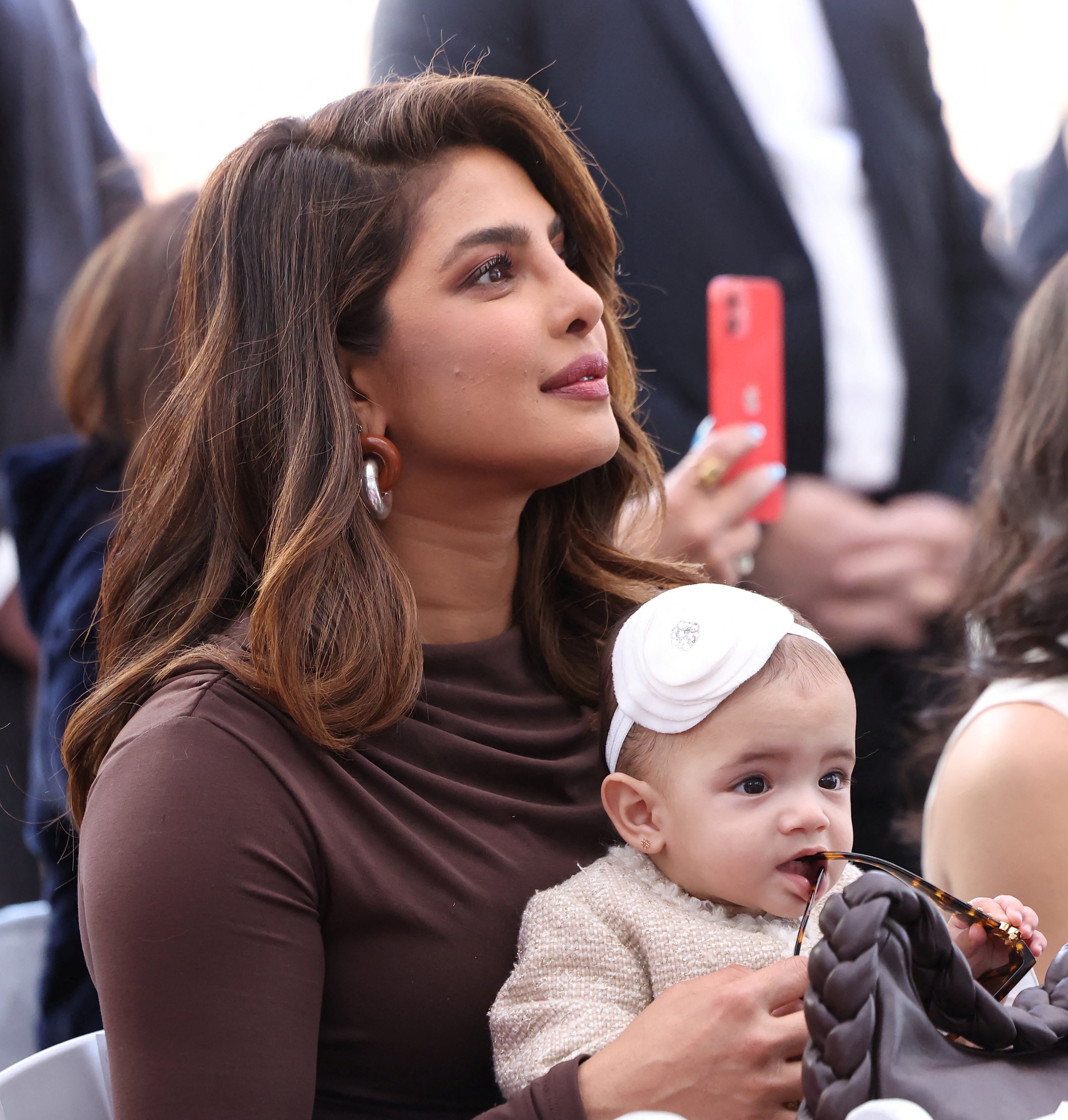 Priyanka Chopra holds her and Nick Jonas' daughter, Malti, during the ceremony where the Jonas Brothers will unveil their star on The Hollywood Walk of Fame in Los Angeles