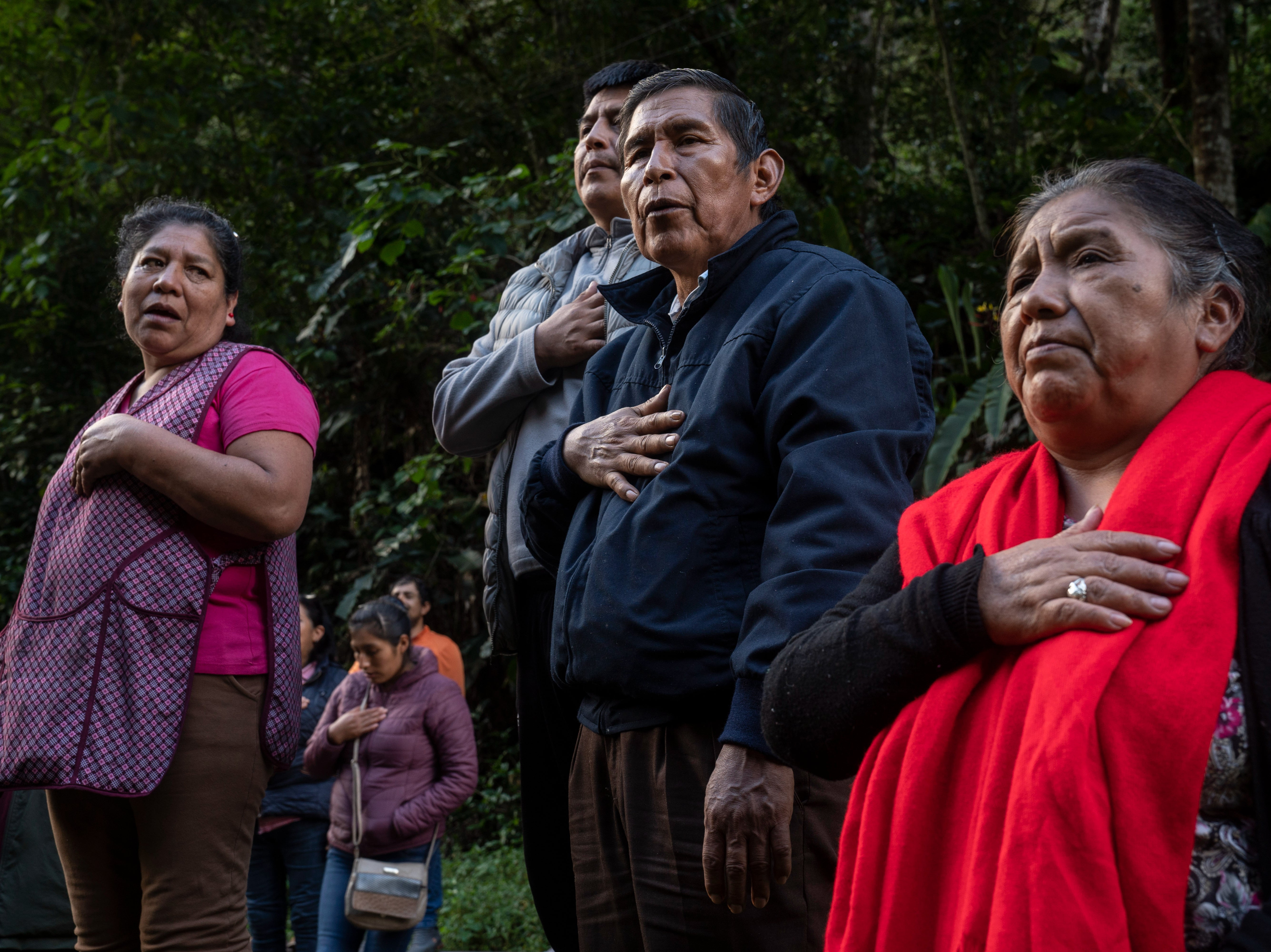 Residents and demonstrators protesting the Peruvian government sing the national anthem