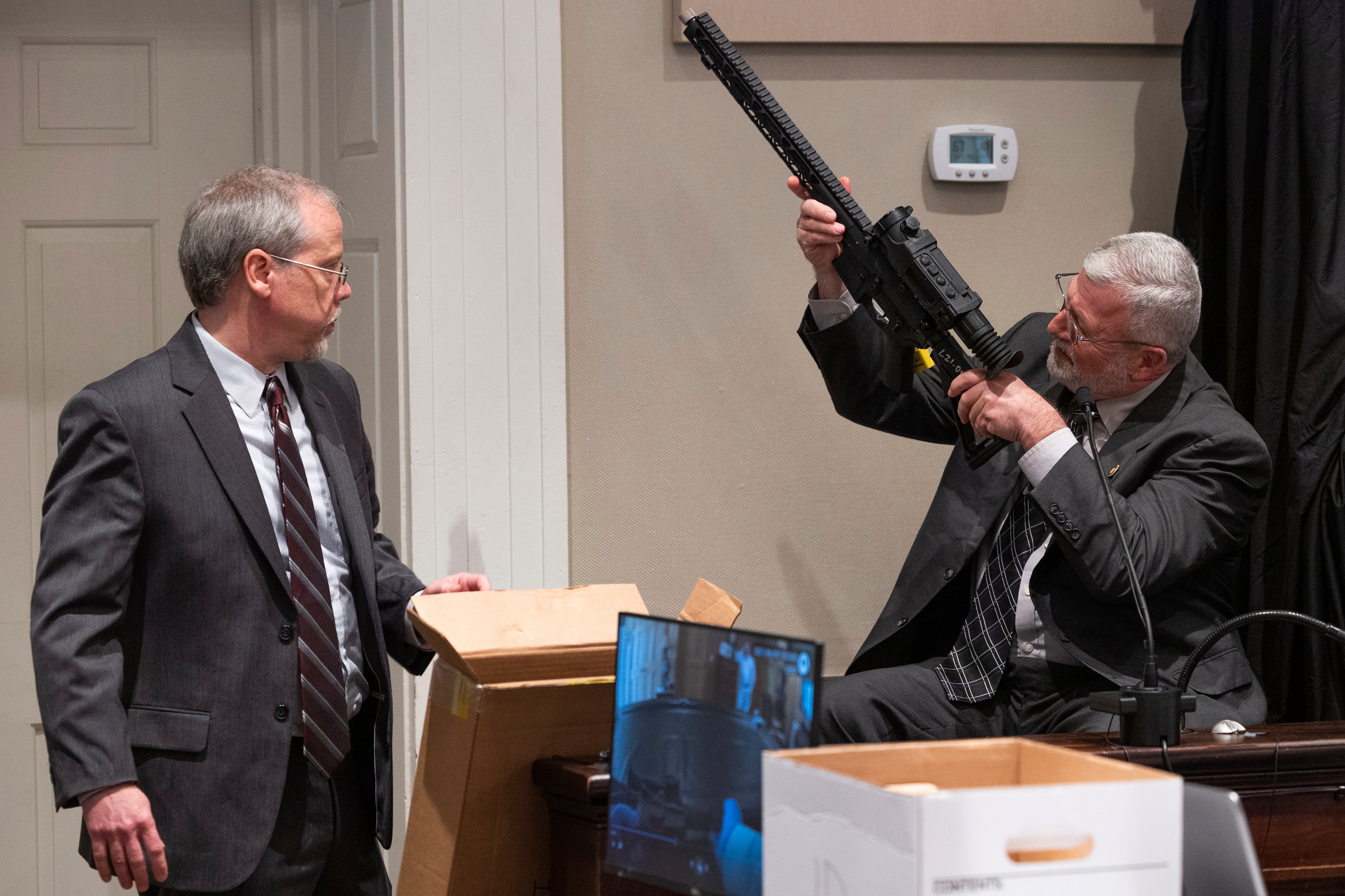 Prosecutor Creighton Waters and witness Jeff Croft, a SLED senior special agent, show jurors one of the guns taken from the Murdaugh property