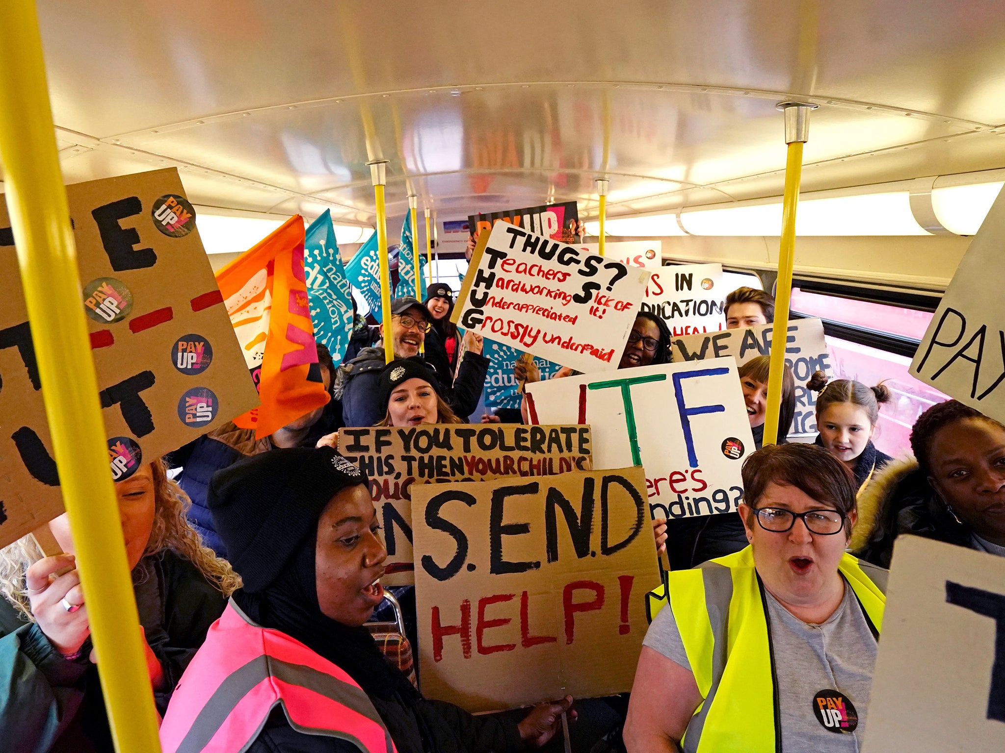 Striking teachers from the National Education Union on board a routemaster bus travelling into central London