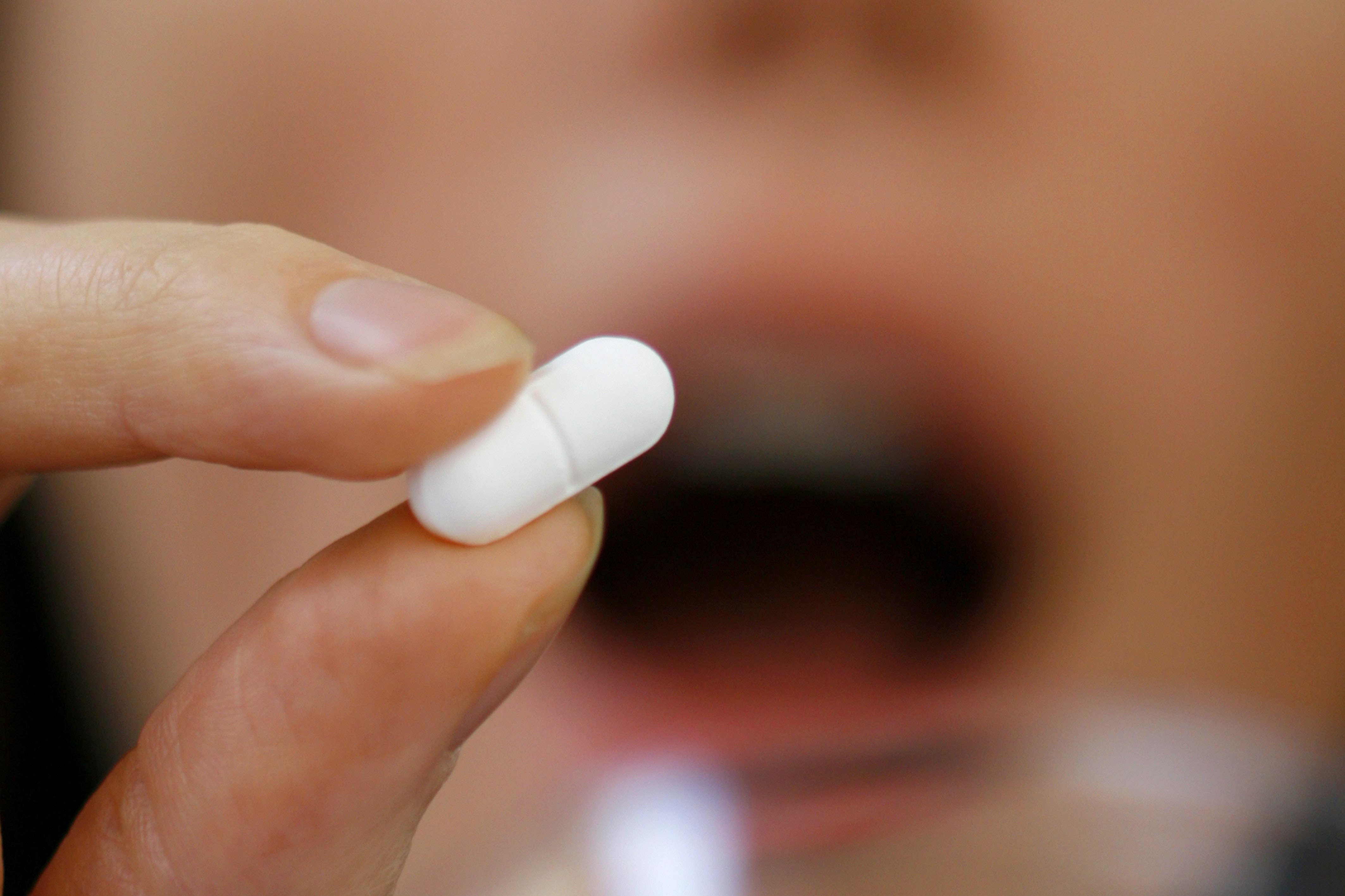 A person taking a tablet (Chris Ison/PA)