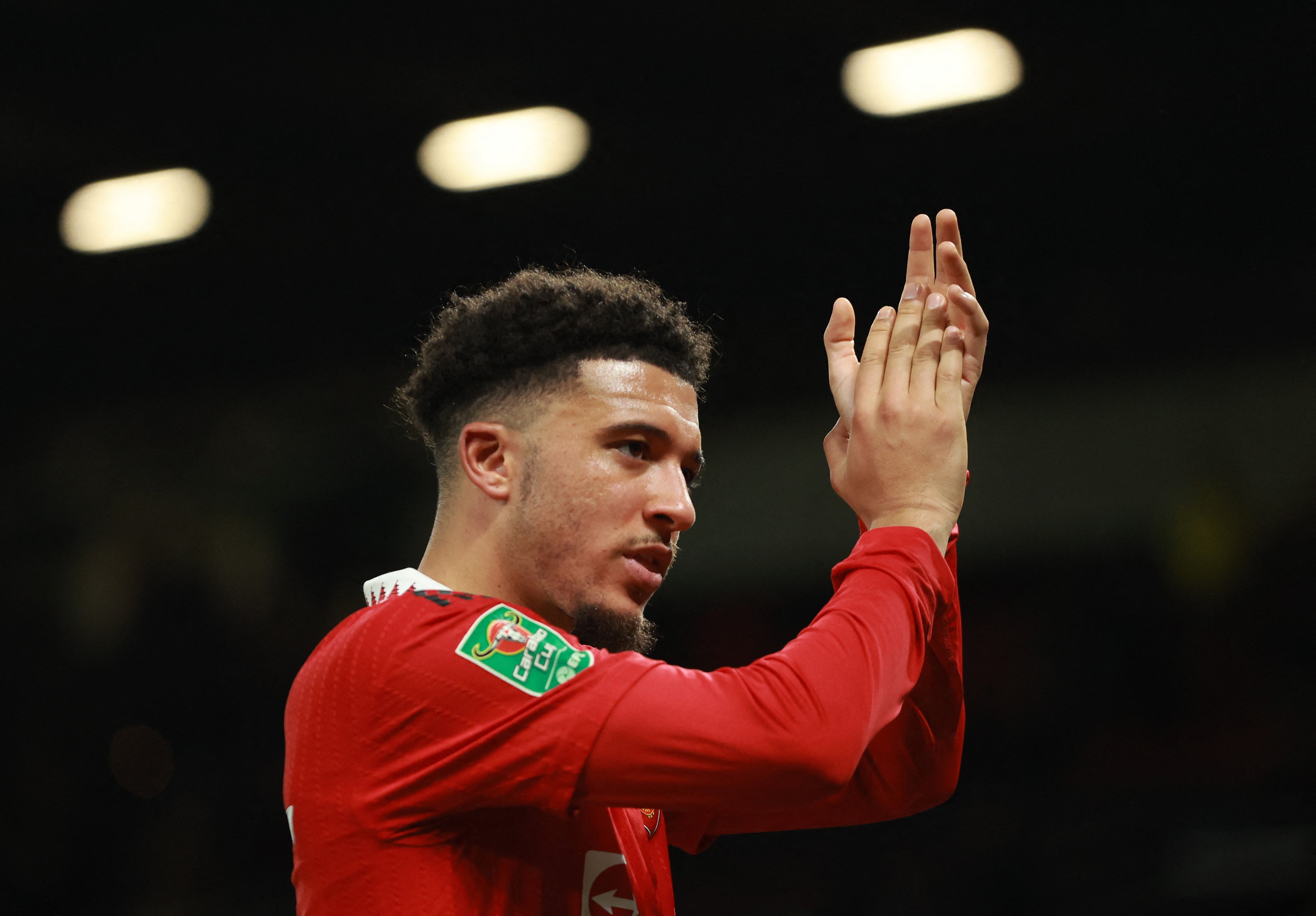 Jadon Sancho applauds the fans at Old Trafford