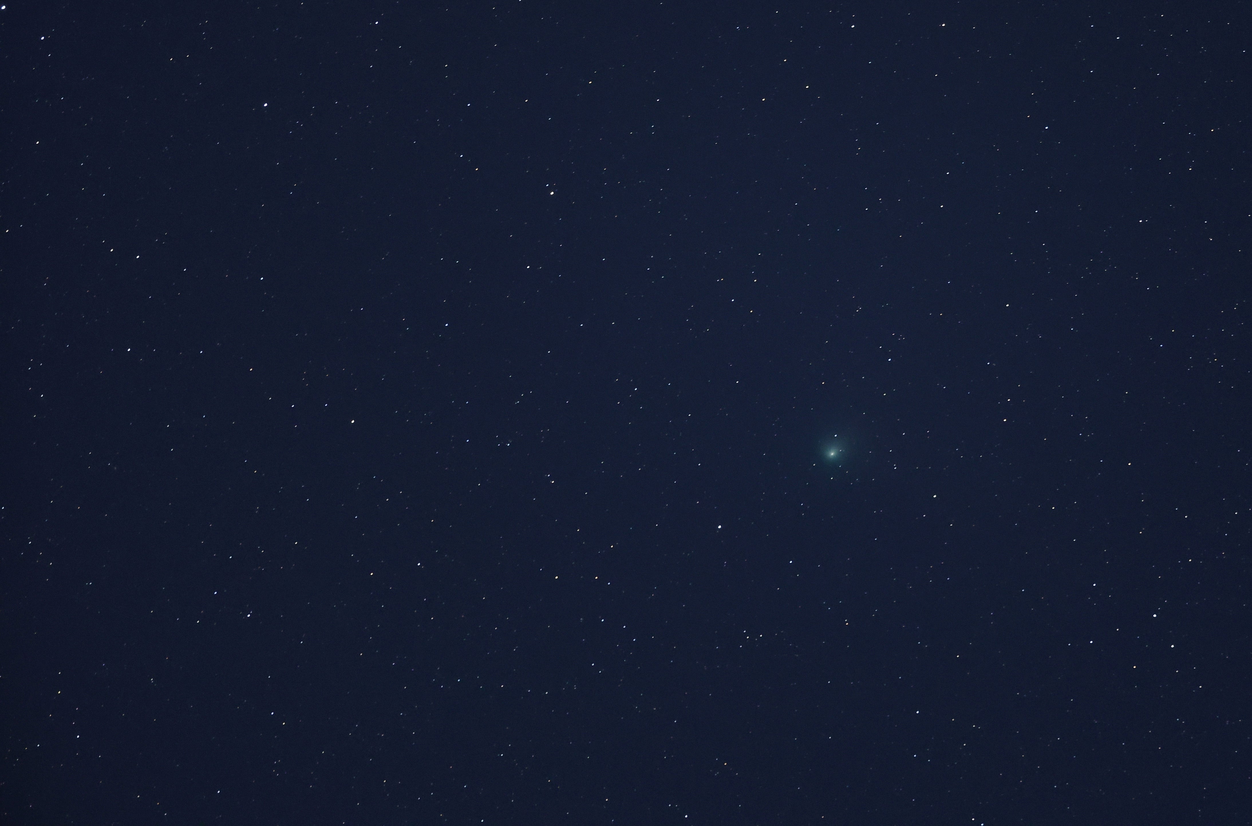 Comet C/2022 E3 (ZTF) is visible in the sky above the Mojave National Preserve in San Bernadino County as it approaches Earth for the first time in about 50,000 years on January 31, 2023 near Baker, California. The comet was discovered on March 2, 2022, and will be at its closest point to Earth on February 1, 2023. Its orbit extends far out into our solar system and has a green aura because it is passing close enough to the sun for the outgassing of its diatomic carbon molecules to react with the solar wind.