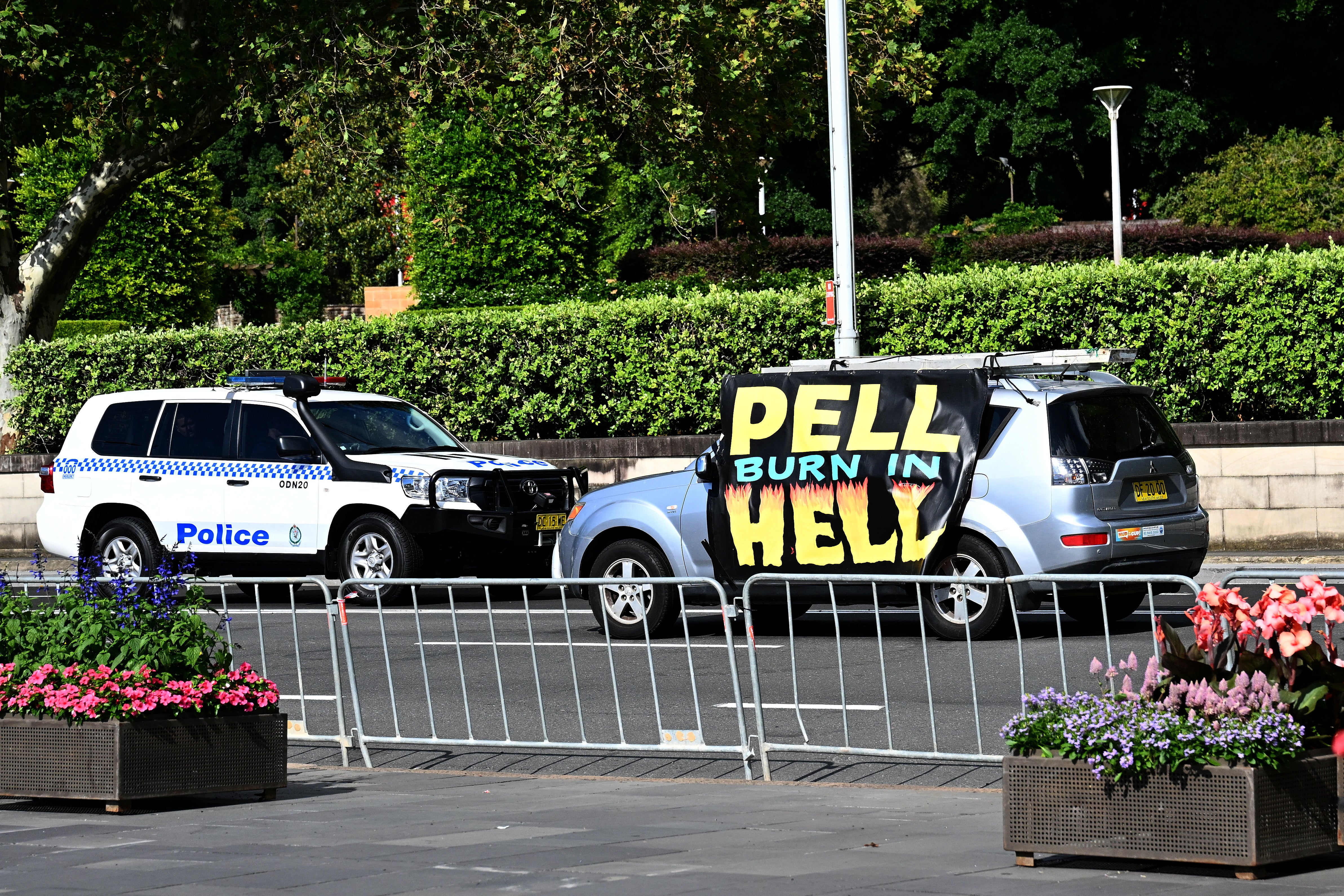 A car carrying a slogan saying ‘Pell Burn In Hell’ ahead of a pontifical requiem Mass for Cardinal George Pell at St Mary’s Cathedral in Sydney