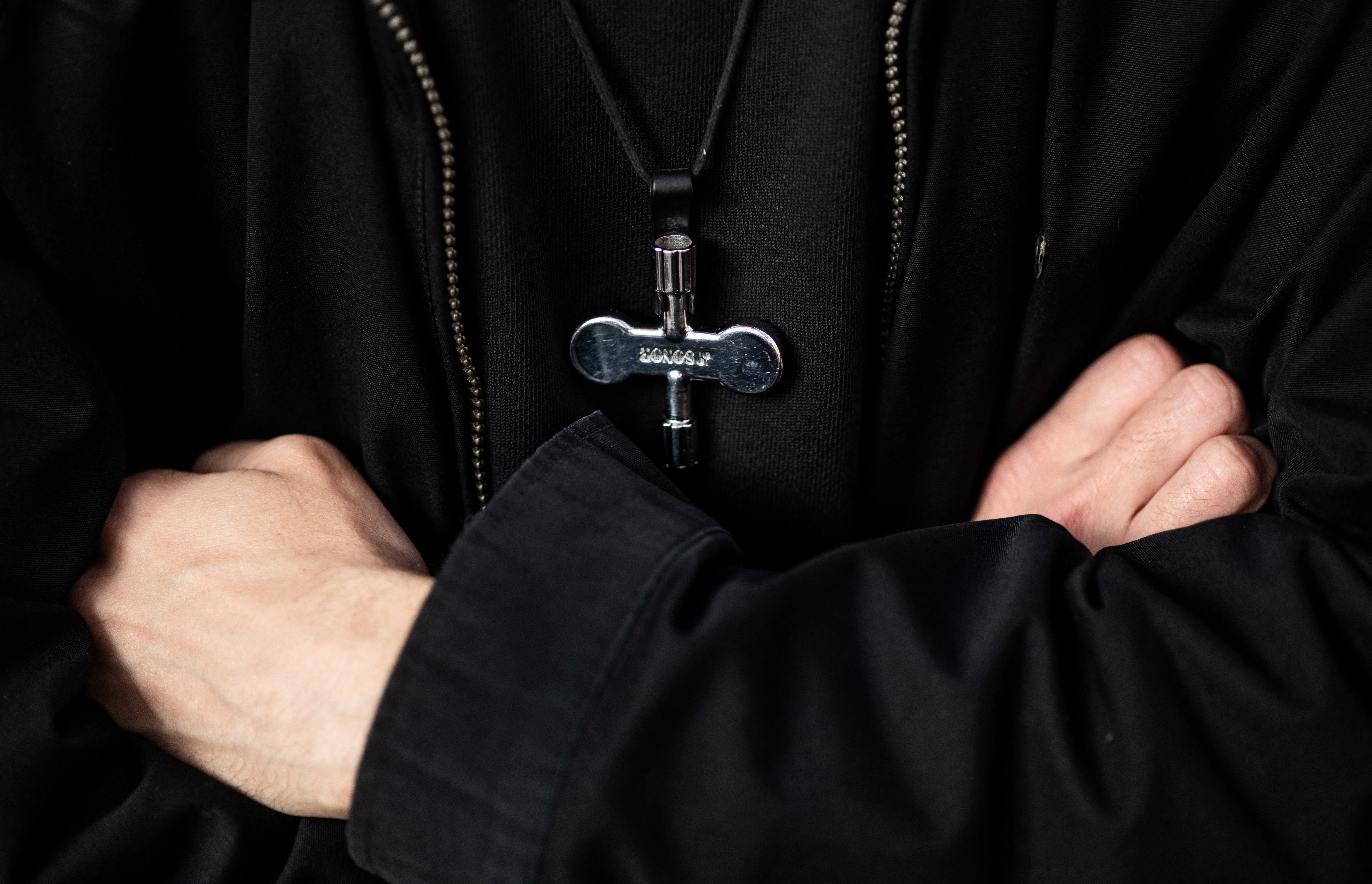 A drum key is seen hanging around Grigory Dobrynin’s neck