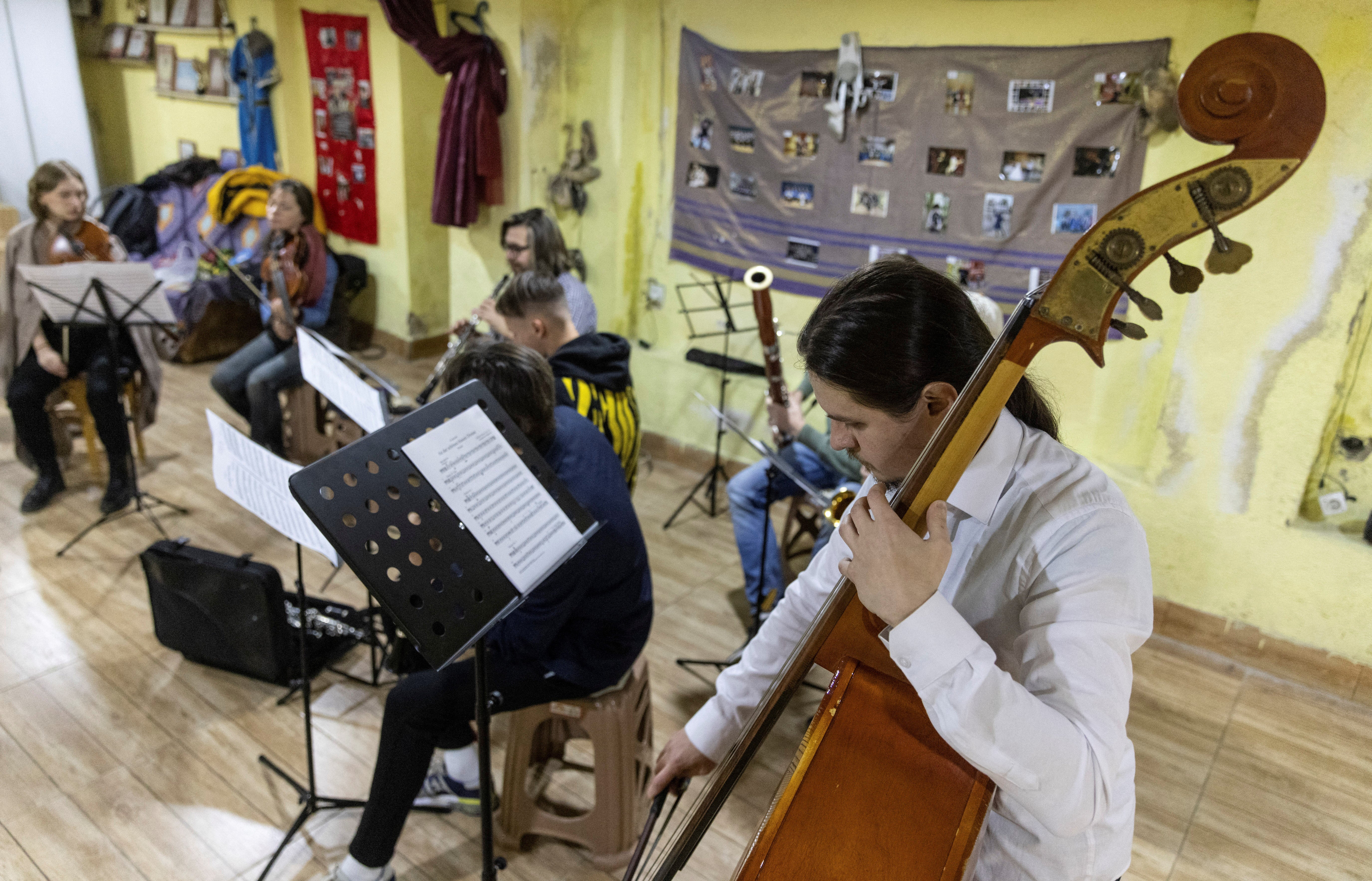 Musicians play during the first rehearsal with the small symphonic orchestra of fellow Russian musicians