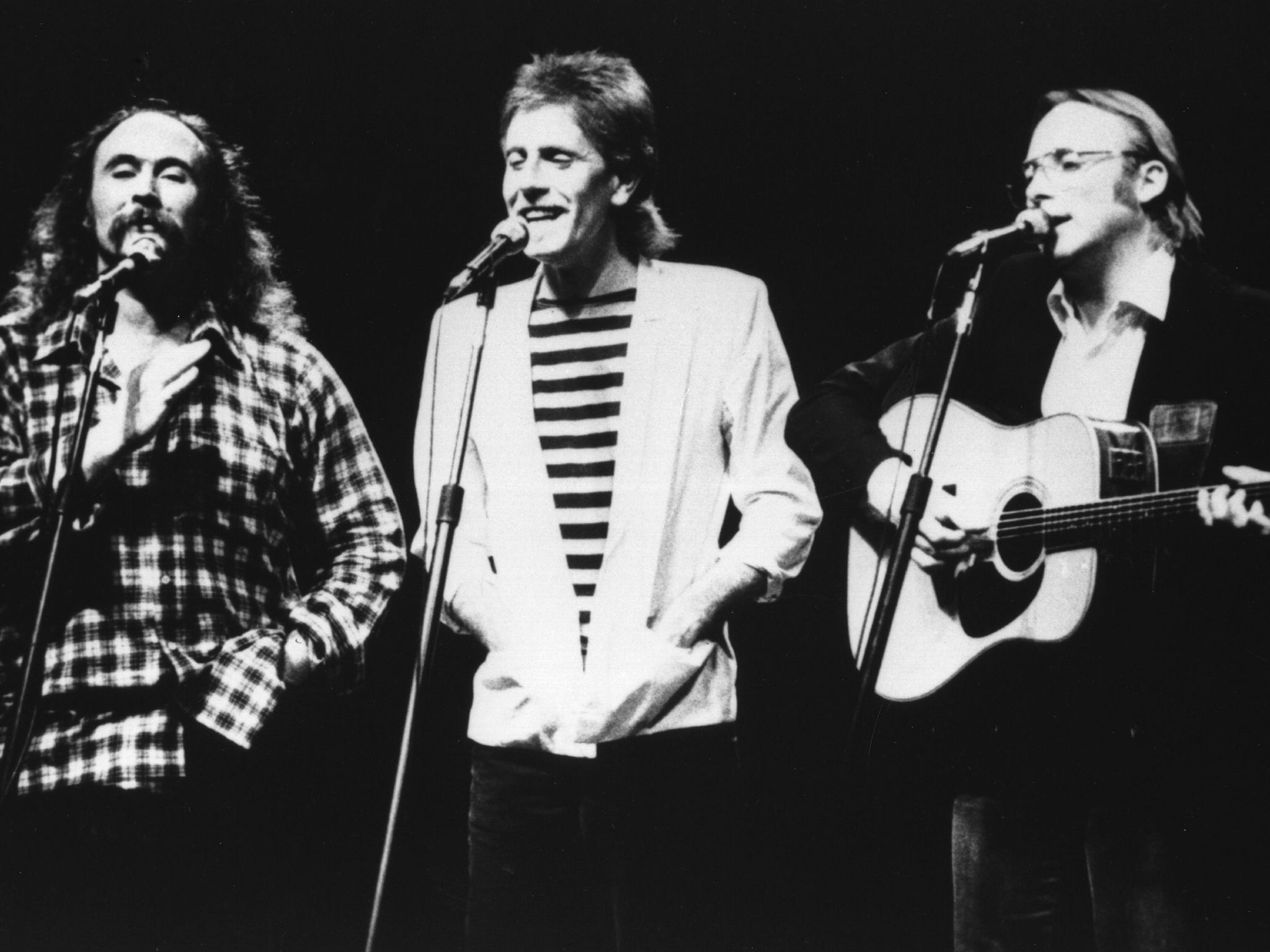 Crosby performing with Graham Nash, centre, and Stephen Stills in 1983