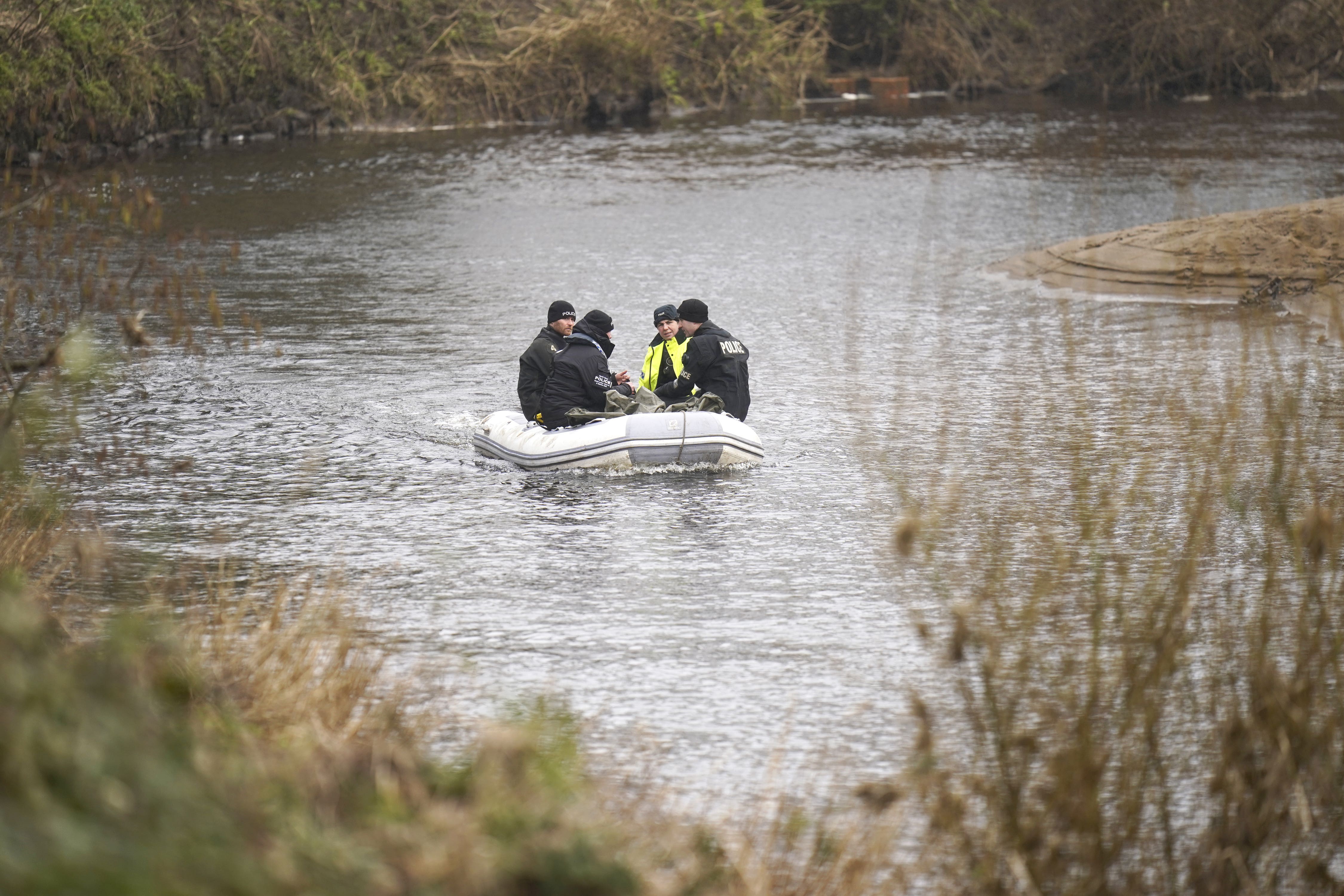 Police officers on the River Wyre, searching for evidence in the case of missing dog walker Nicola Bulley