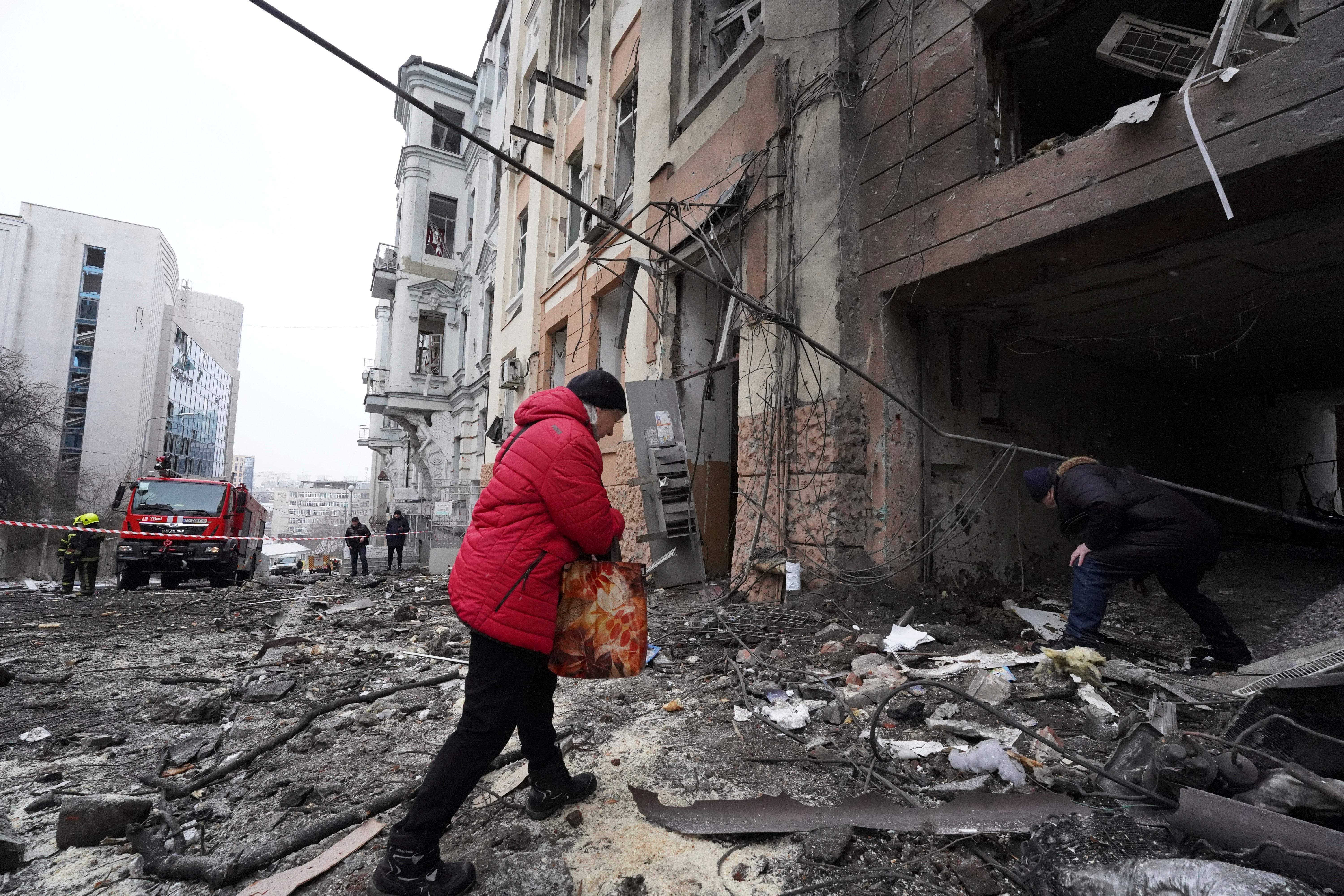 Owners of apartments enter a residential building which was hit by a Russian rocket at the city center of Kharkiv on Sunday