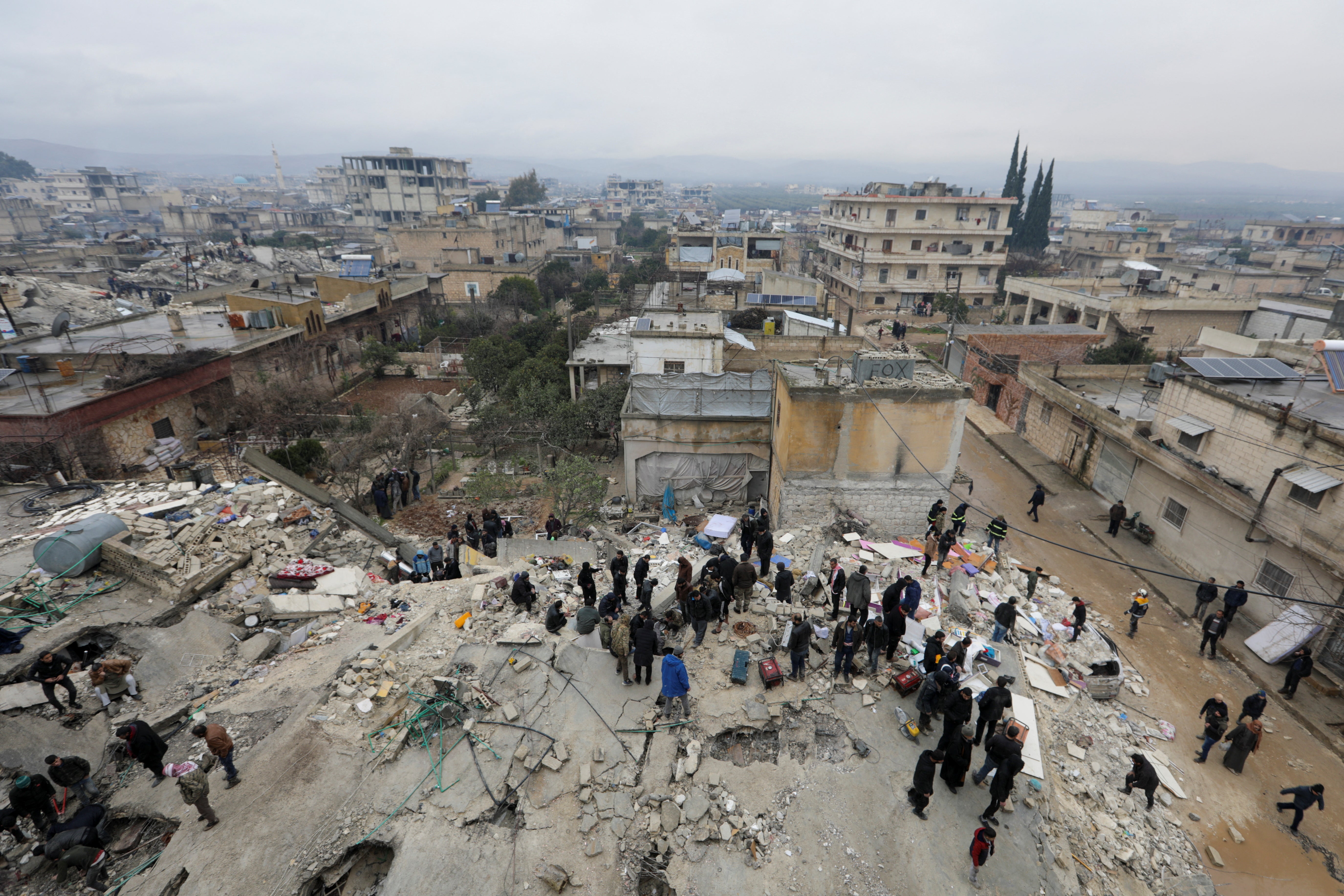 Rescuers prepare to search for survivors in the rebel-held town of Jandaris, Syria