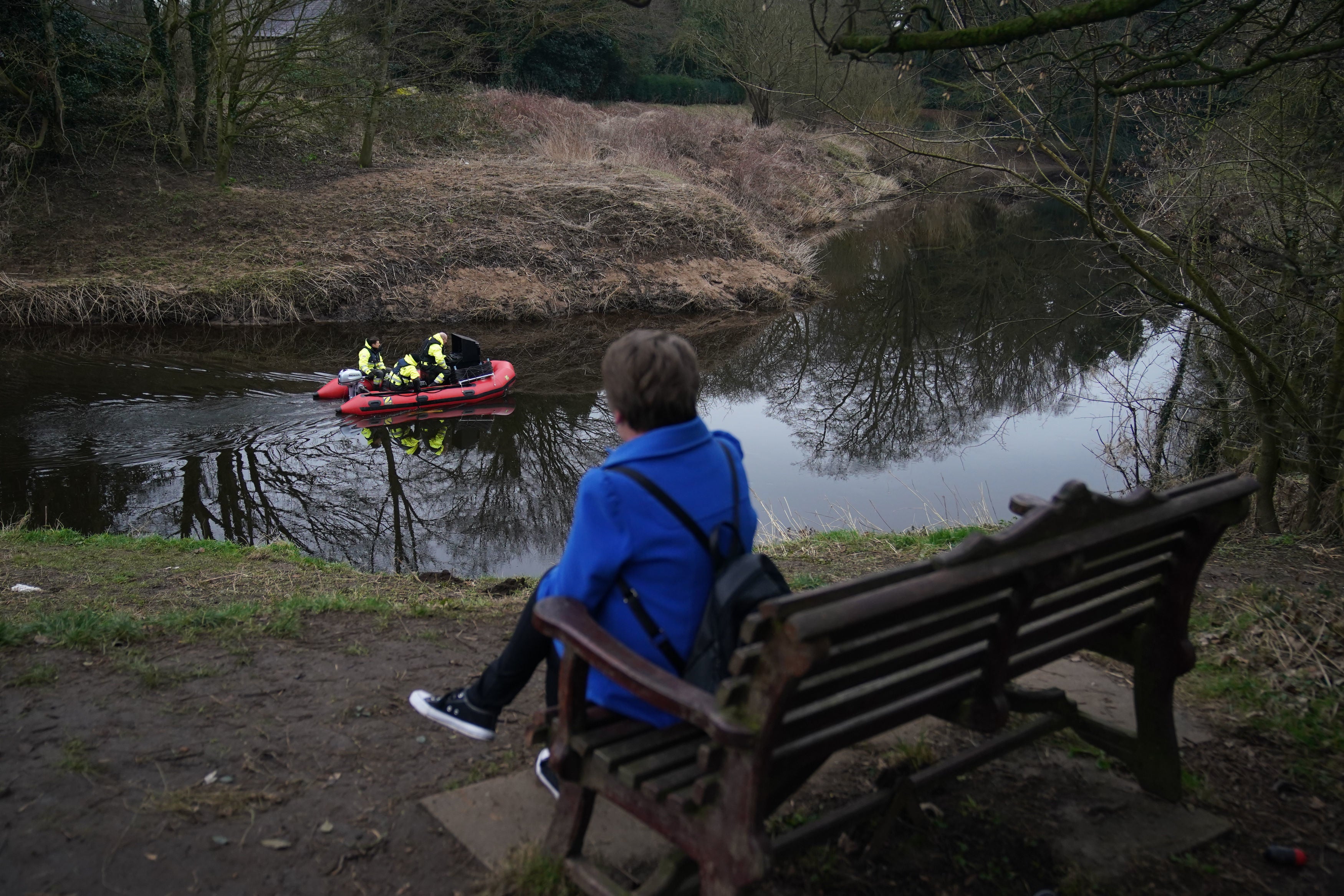 A woman sits on the bench where Nicola Bulley’s belongings were found