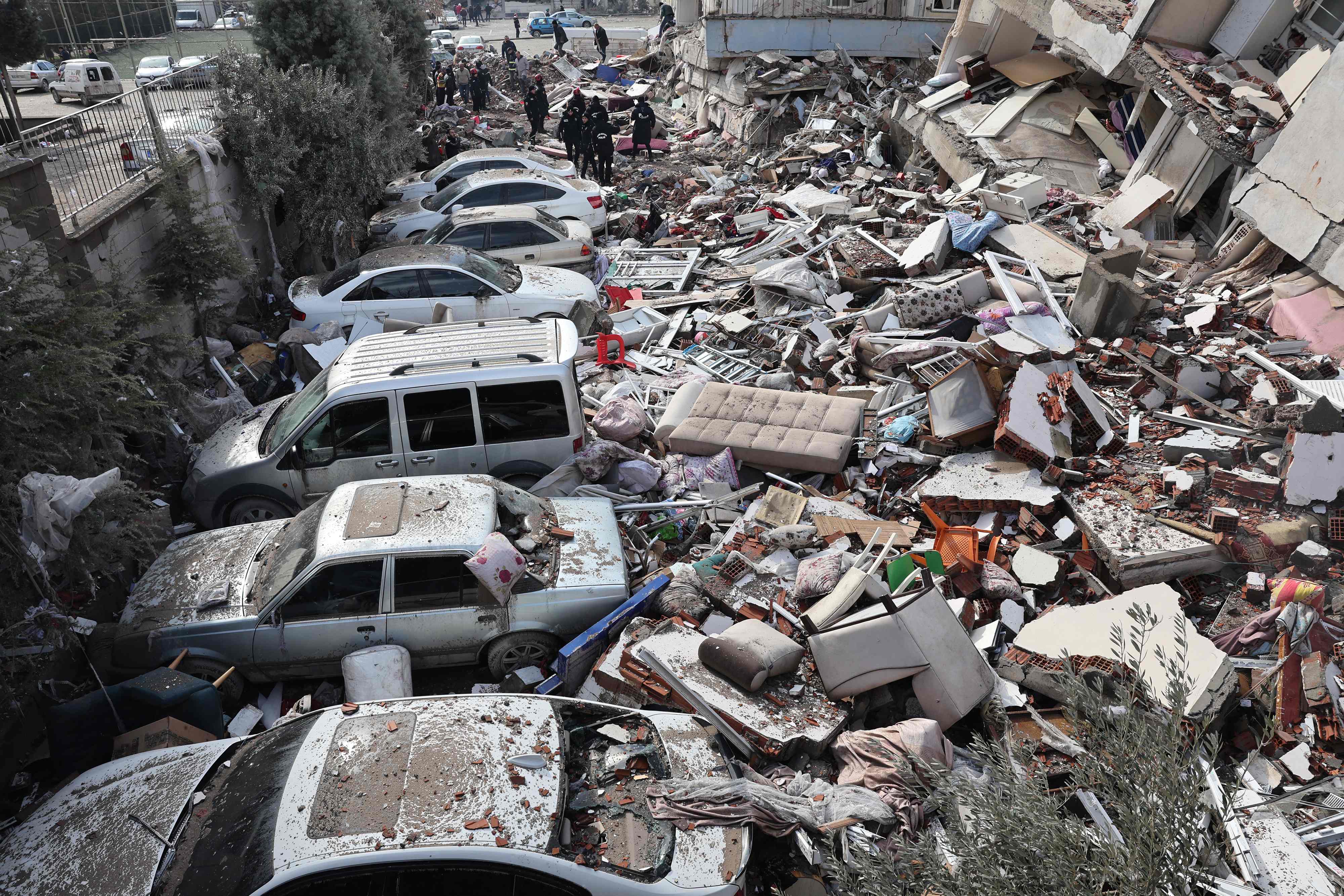 Vehicles are crushed under the rubble of collapsed buildings in Kahramanmaras