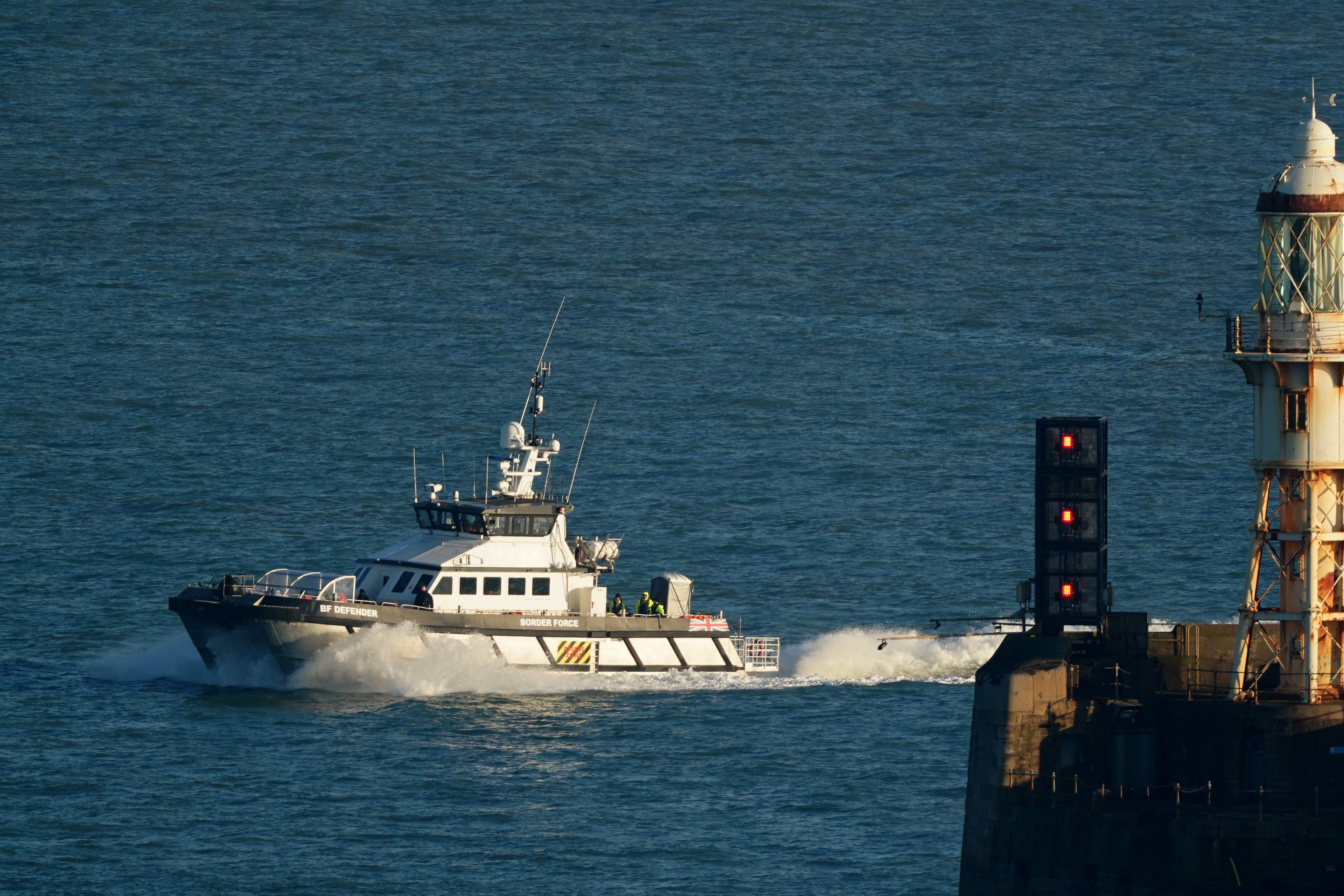 A group of people thought to be migrants are brought in to Dover (PA)