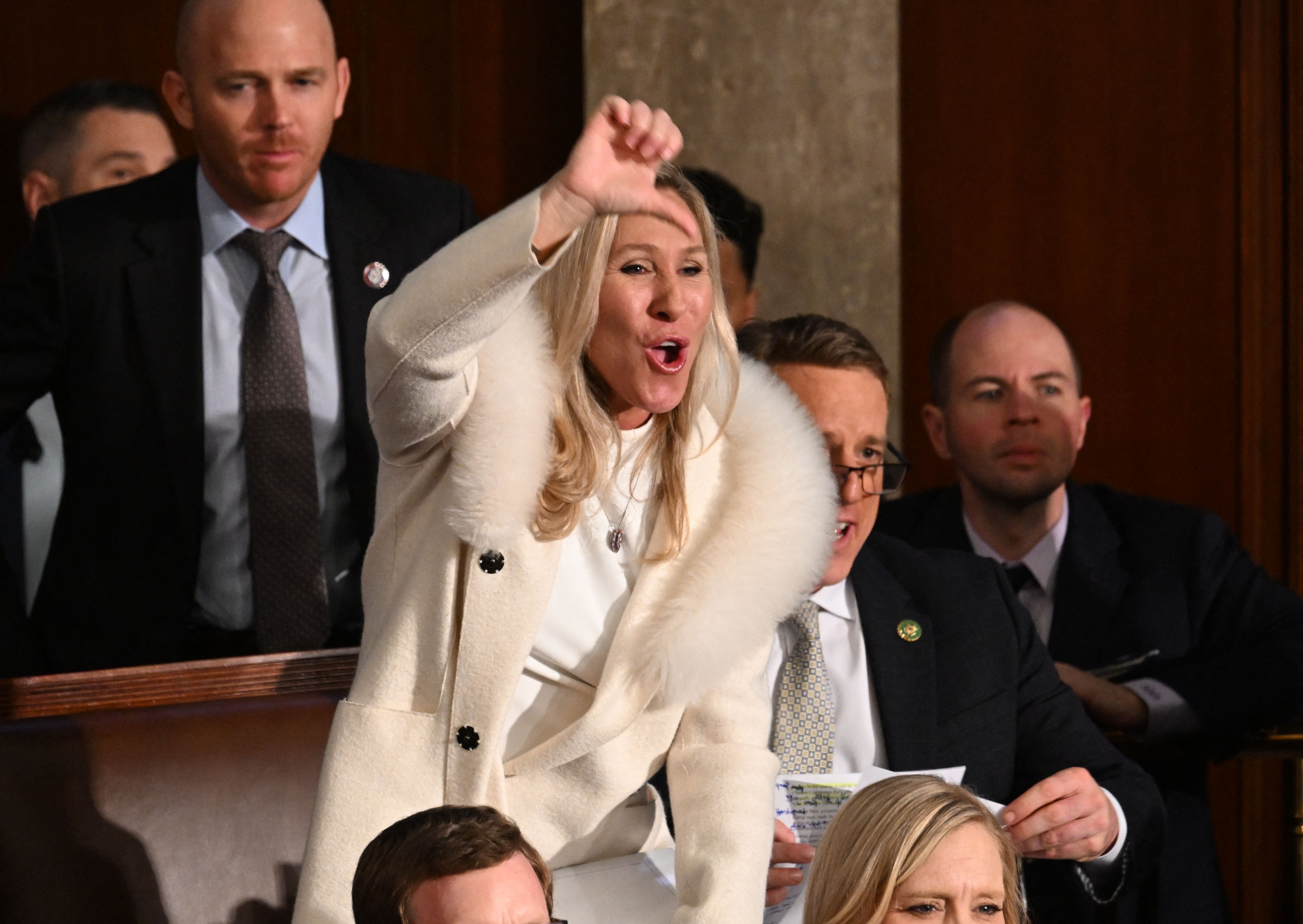 Marjorie Taylor Greene gives a thumb down as US President Joe Biden delivers the State of the Union address