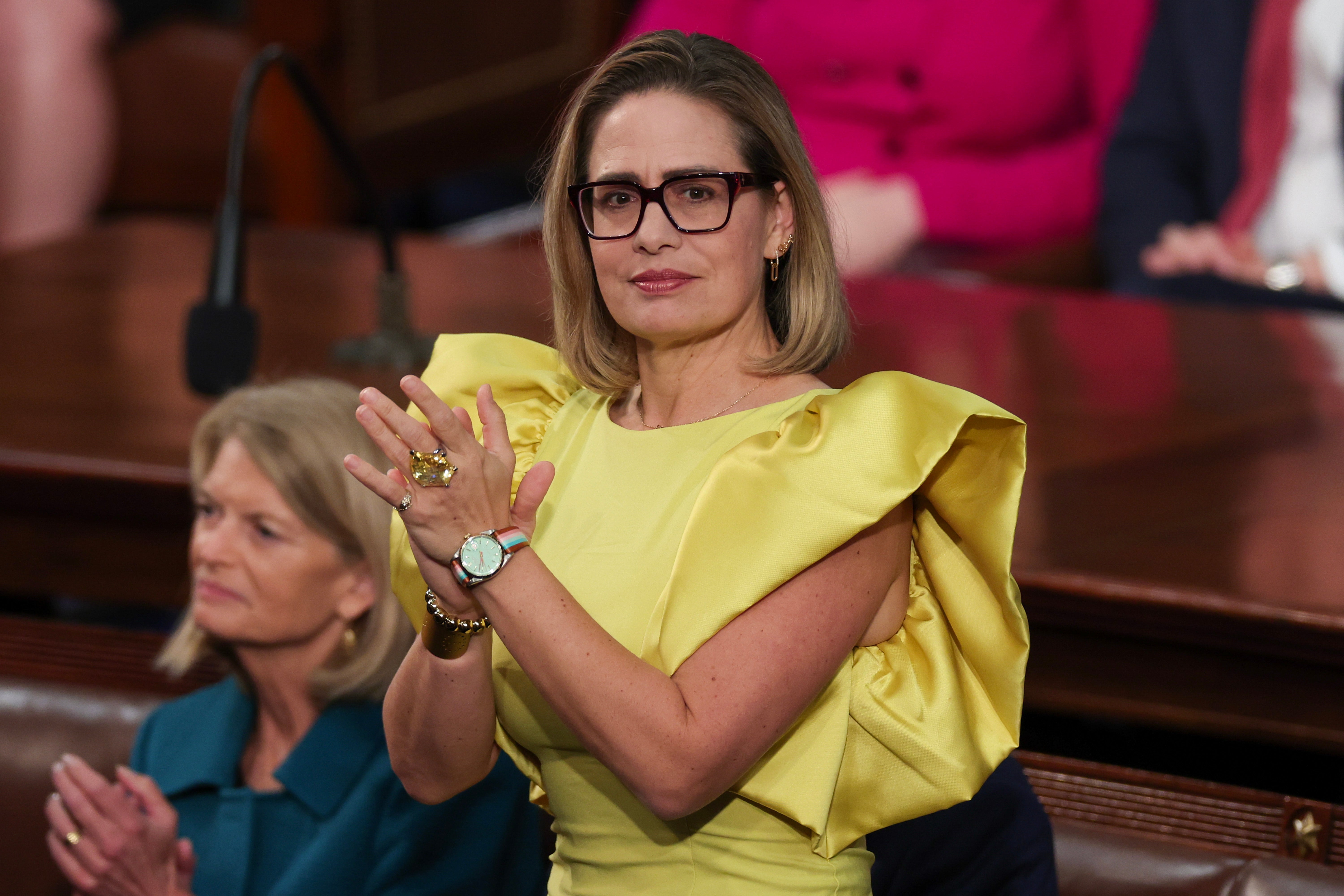 U.S. Senator Kyrsten Sinema applauds during U.S. President Joe Biden's State of the Union address