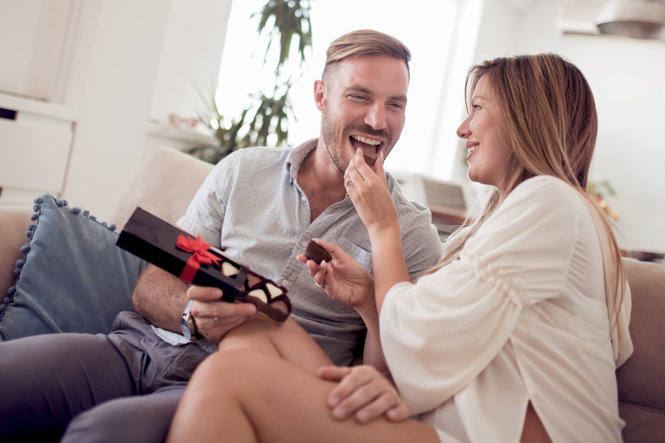 A couple in the erotic throes of opening a box of chocolates