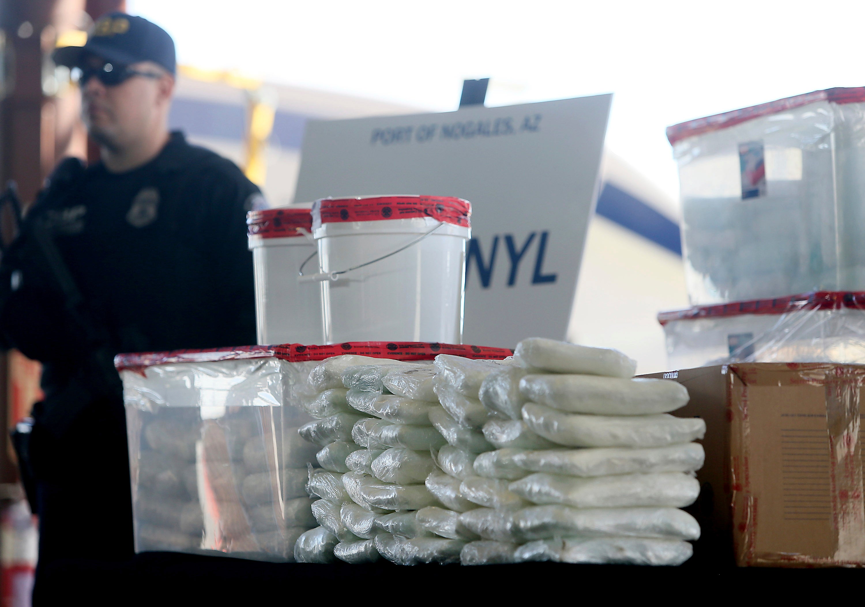 US Customs and Border Protection officers display the haul from a seizure of fentanyl and methamphetamines at the border in Nogales, Arizona