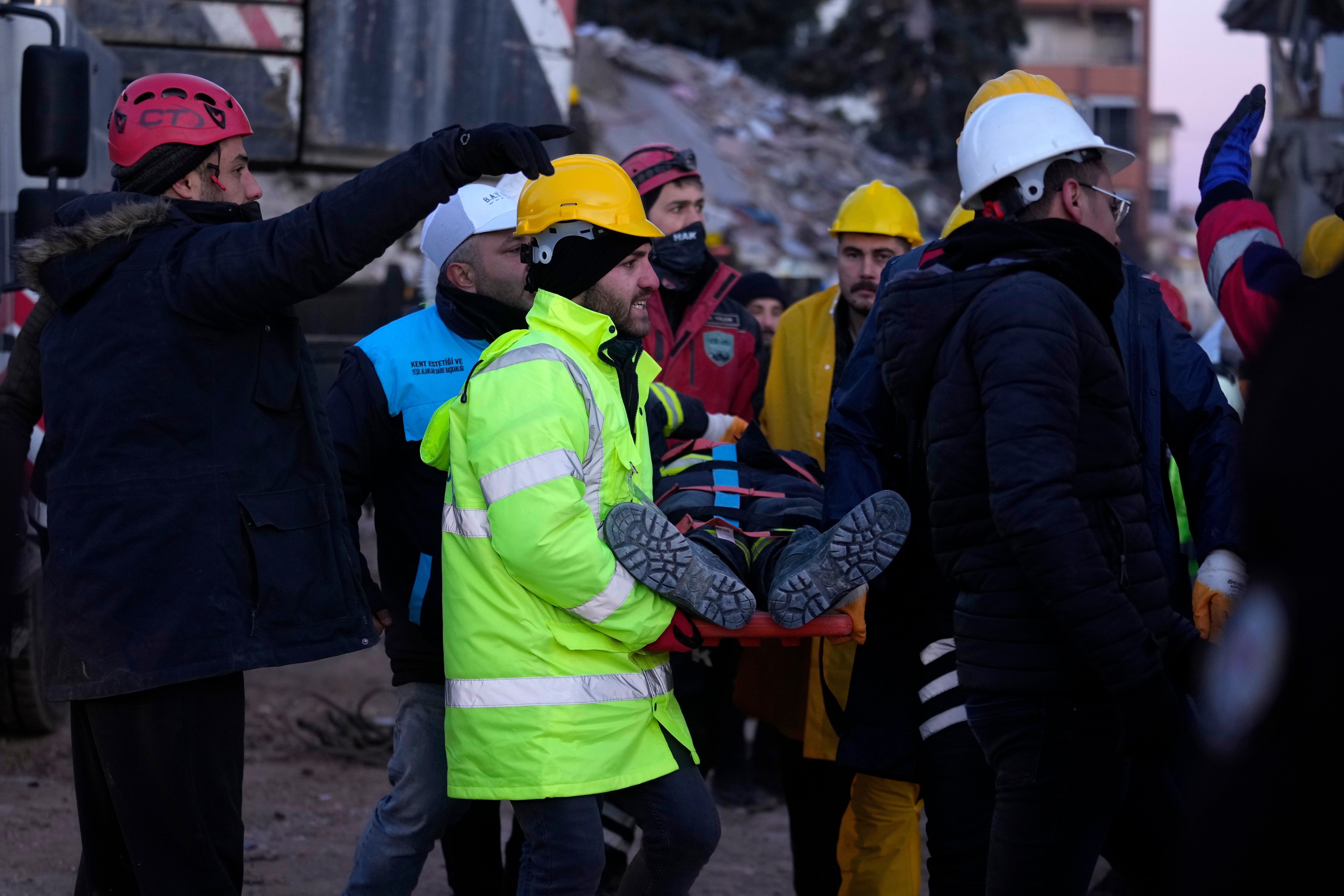 Rescue workers continue to pull injured survivors out of the ruins