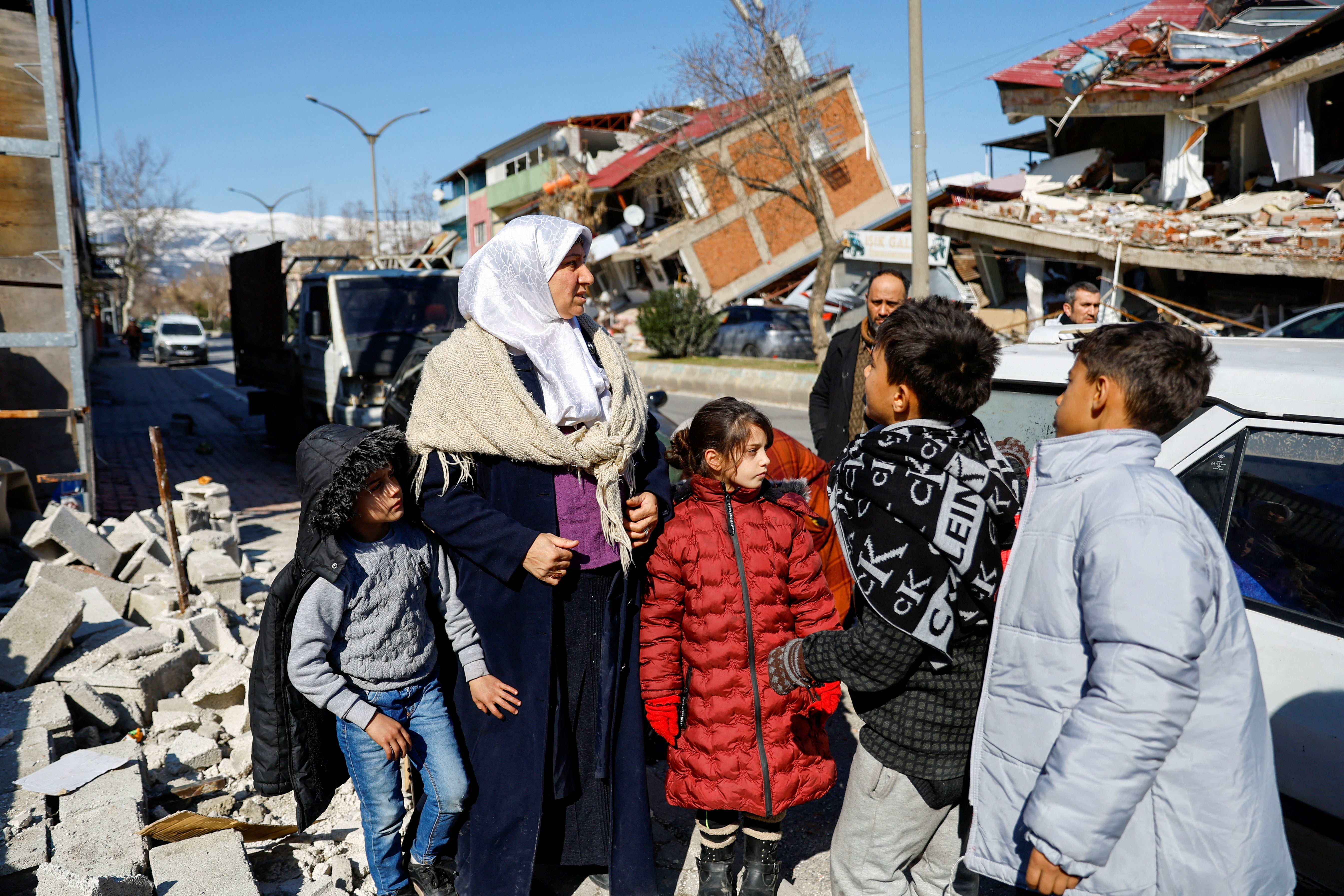 Members of a Syrian family, whose house was destroyed during the war in Syria and later moved to Turkey, gather after their home was left in ruins